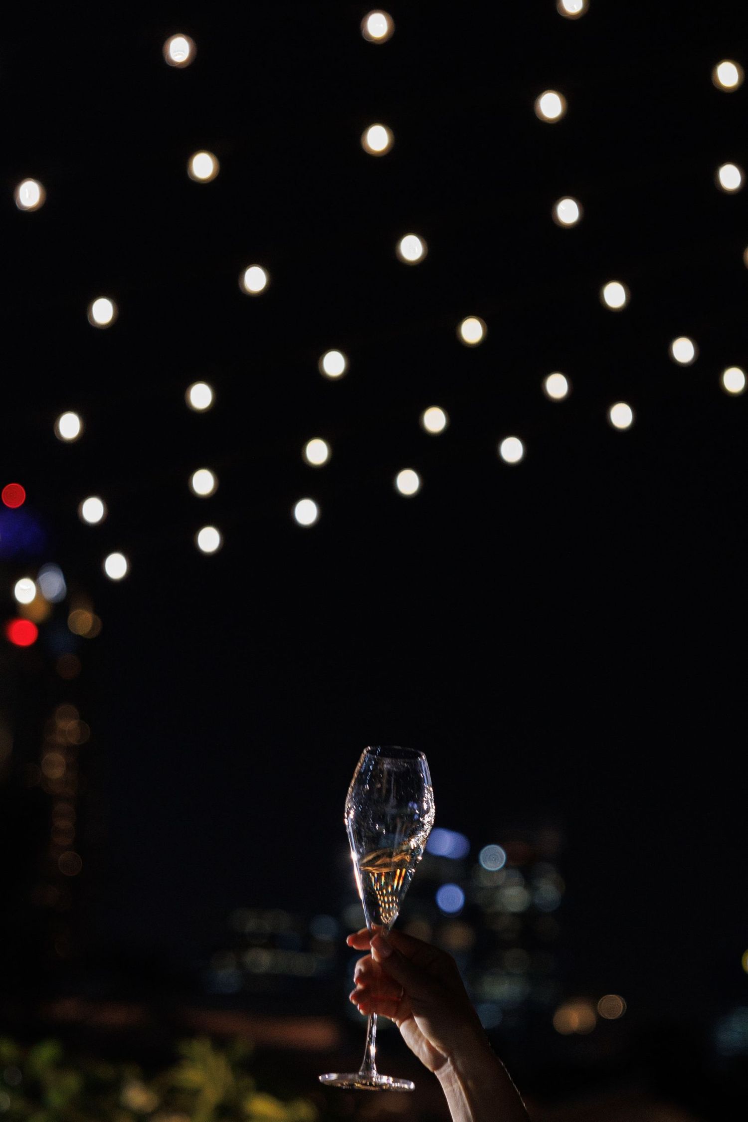 String lights illuminate a dark outdoor venue creating a romantic ambiance.