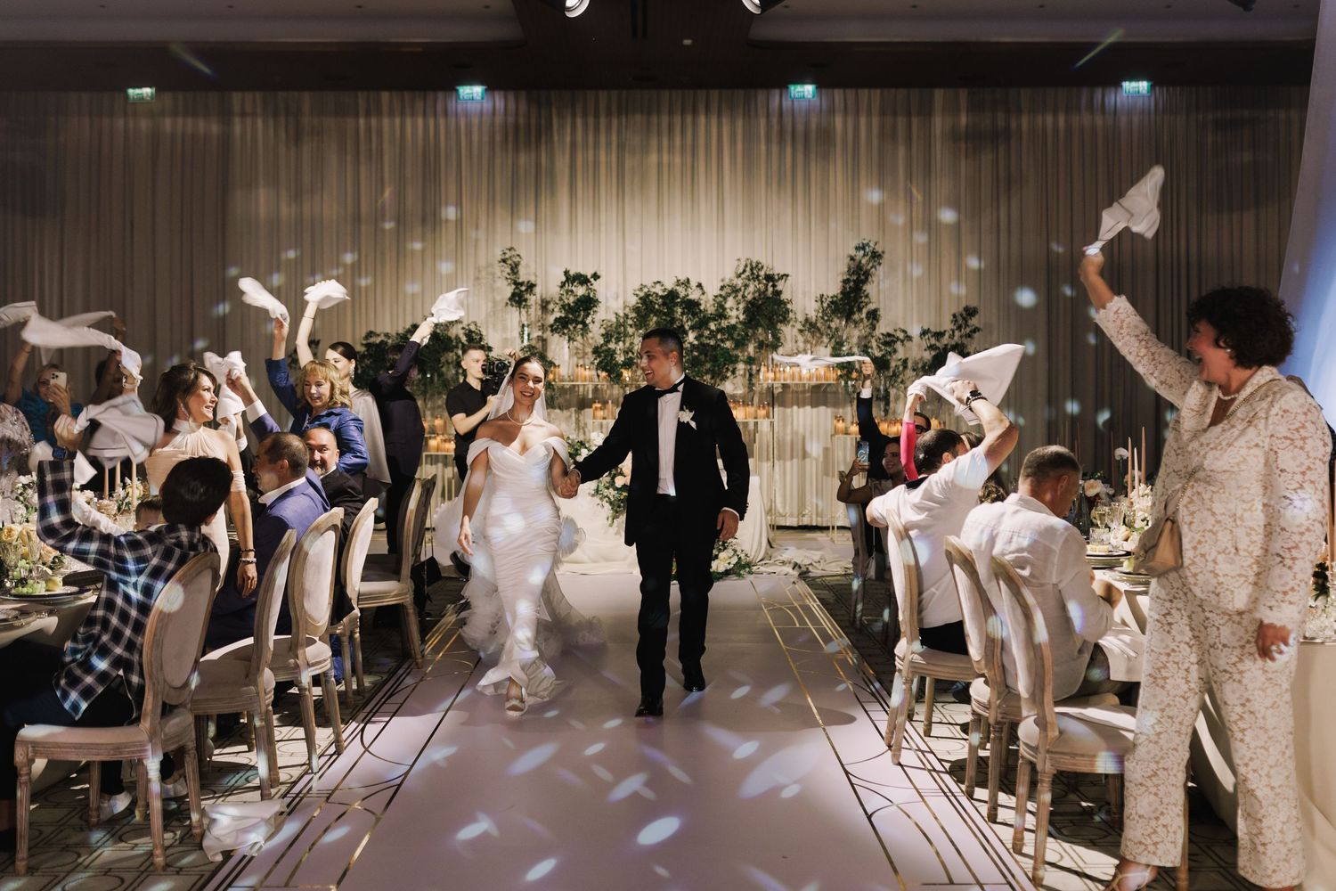 Wedding reception celebration with guests dancing and enjoying festivities on the dance floor.