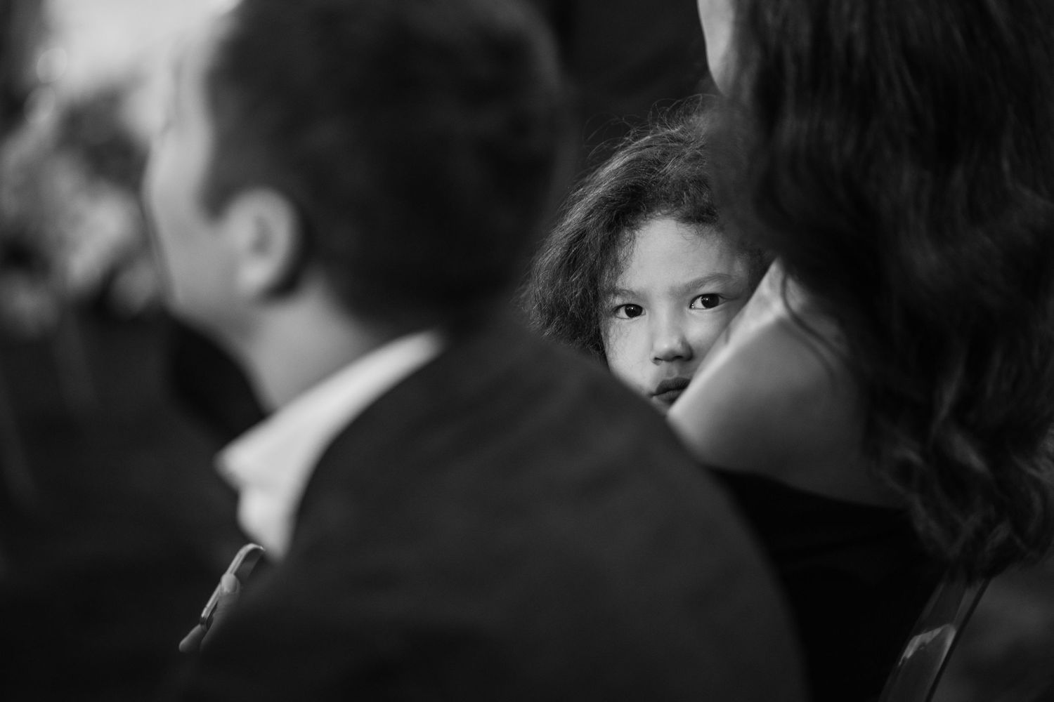 Black and white candid shots of wedding ceremony attendees.