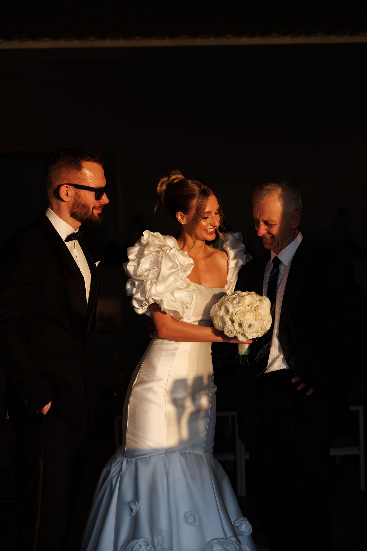 Evening wedding reception scene with dancing couples in formal attire.