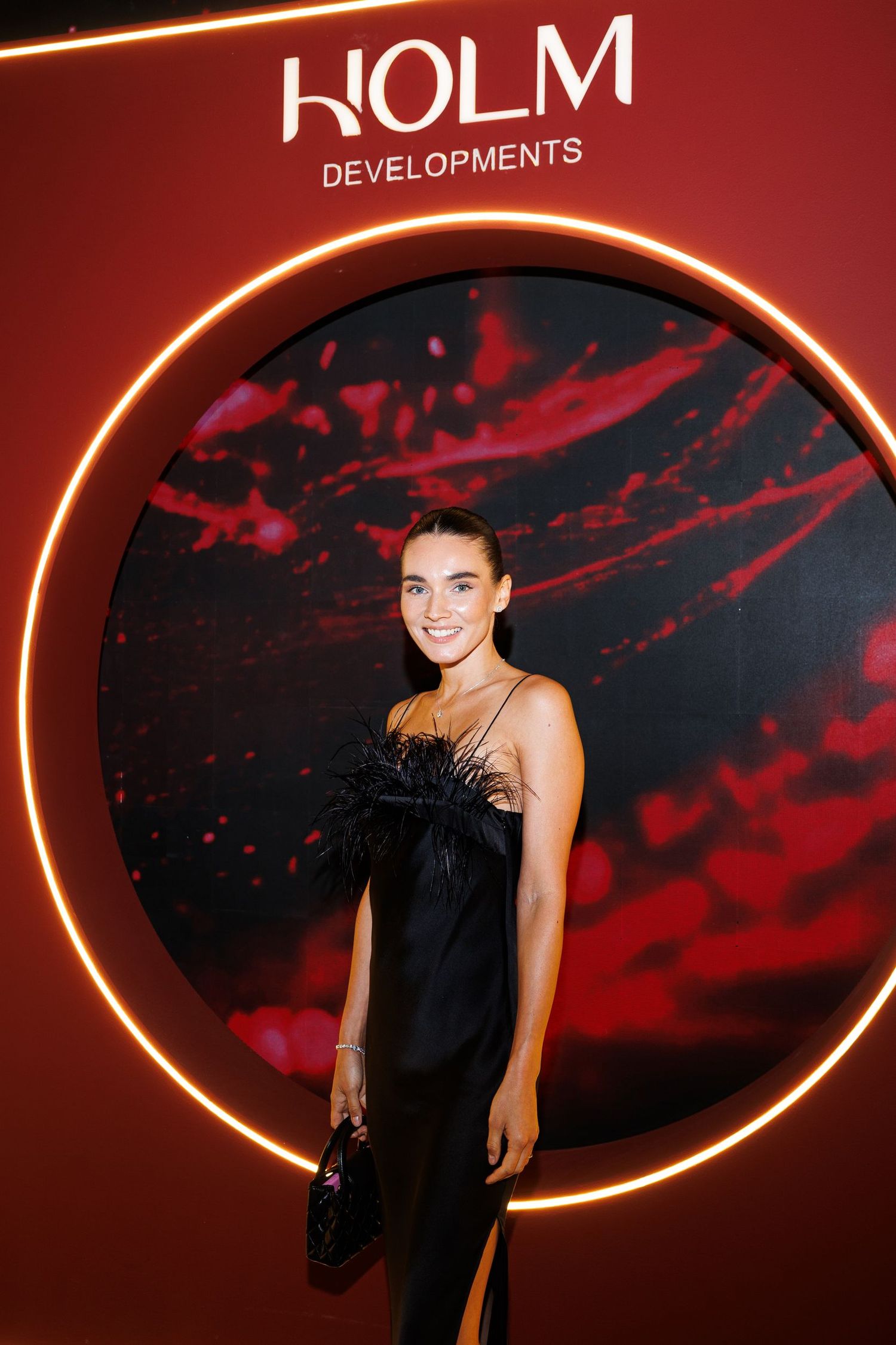 Elegant event space with KOLM branding and dramatic red lighting design.
