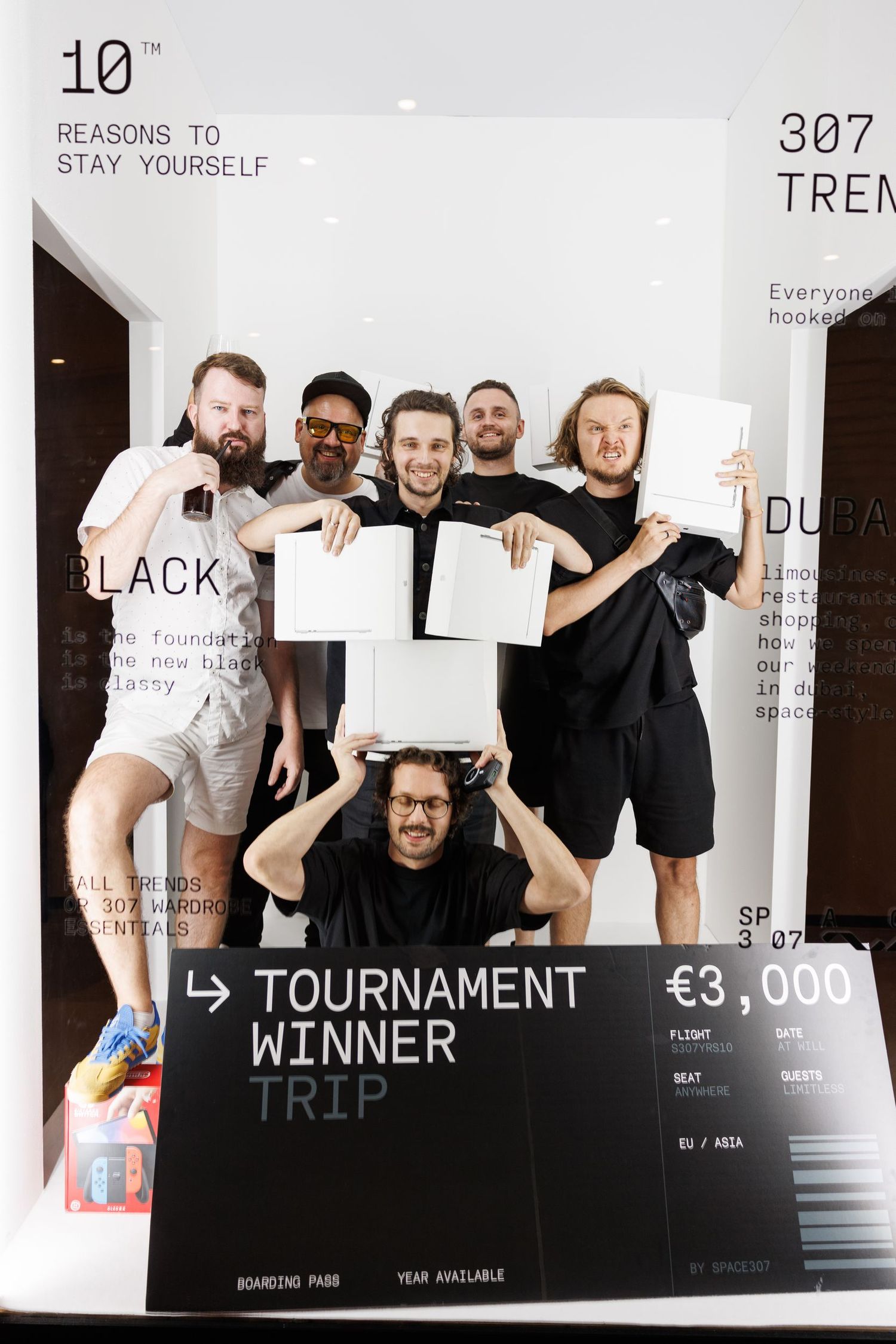 Group poses with tournament winner certificates against white backdrop with text overlay.