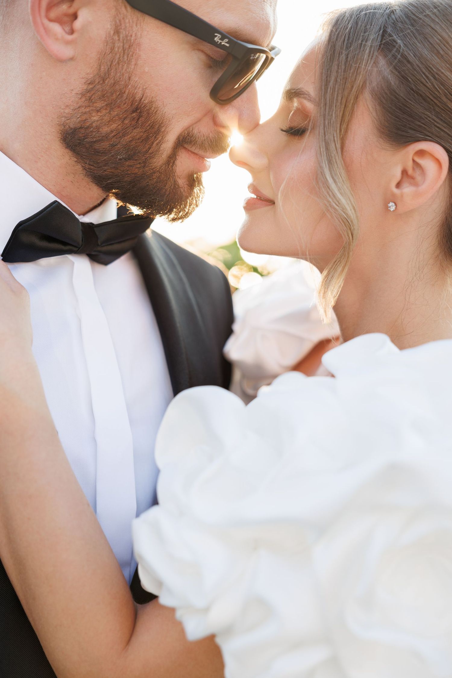 Intimate wedding couple portrait showing romantic moment in formal attire.