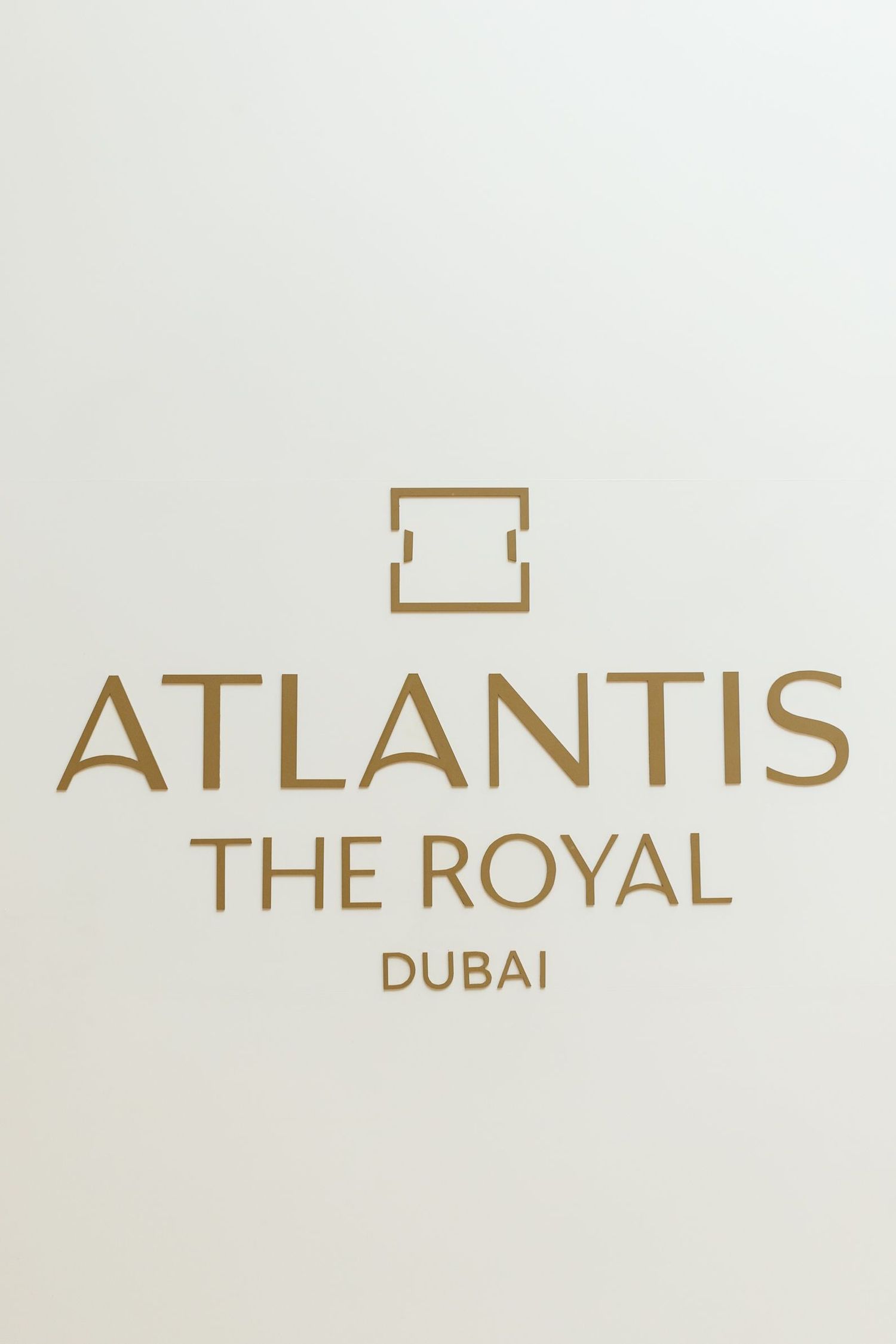 Atlantis The Royal Dubai logo displayed in elegant gold text on white background.