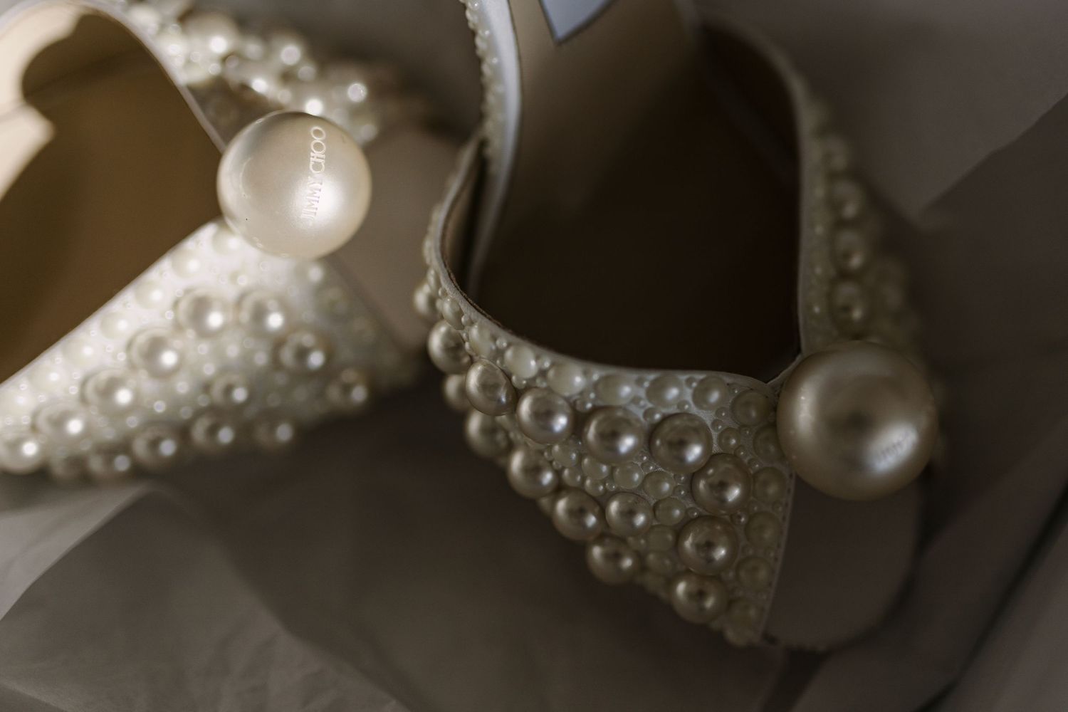 Pearl-embellished bridal shoes photographed in elegant detail.