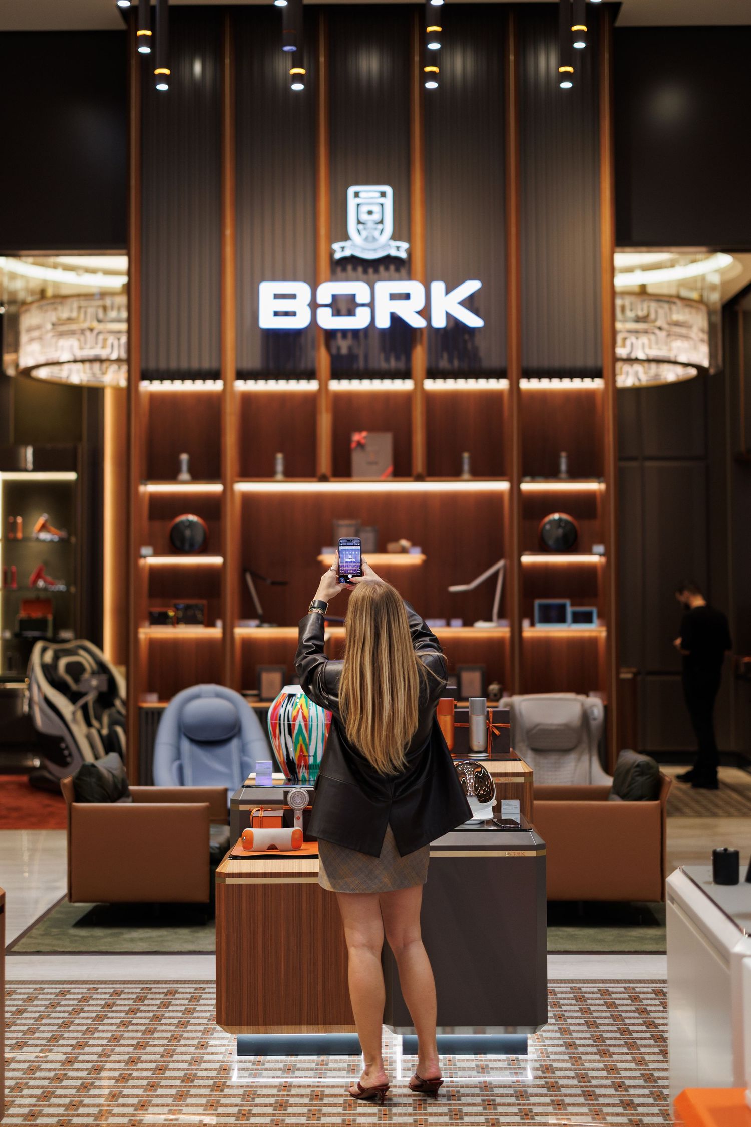 Modern retail store interior with BORK signage and luxurious seating area.
