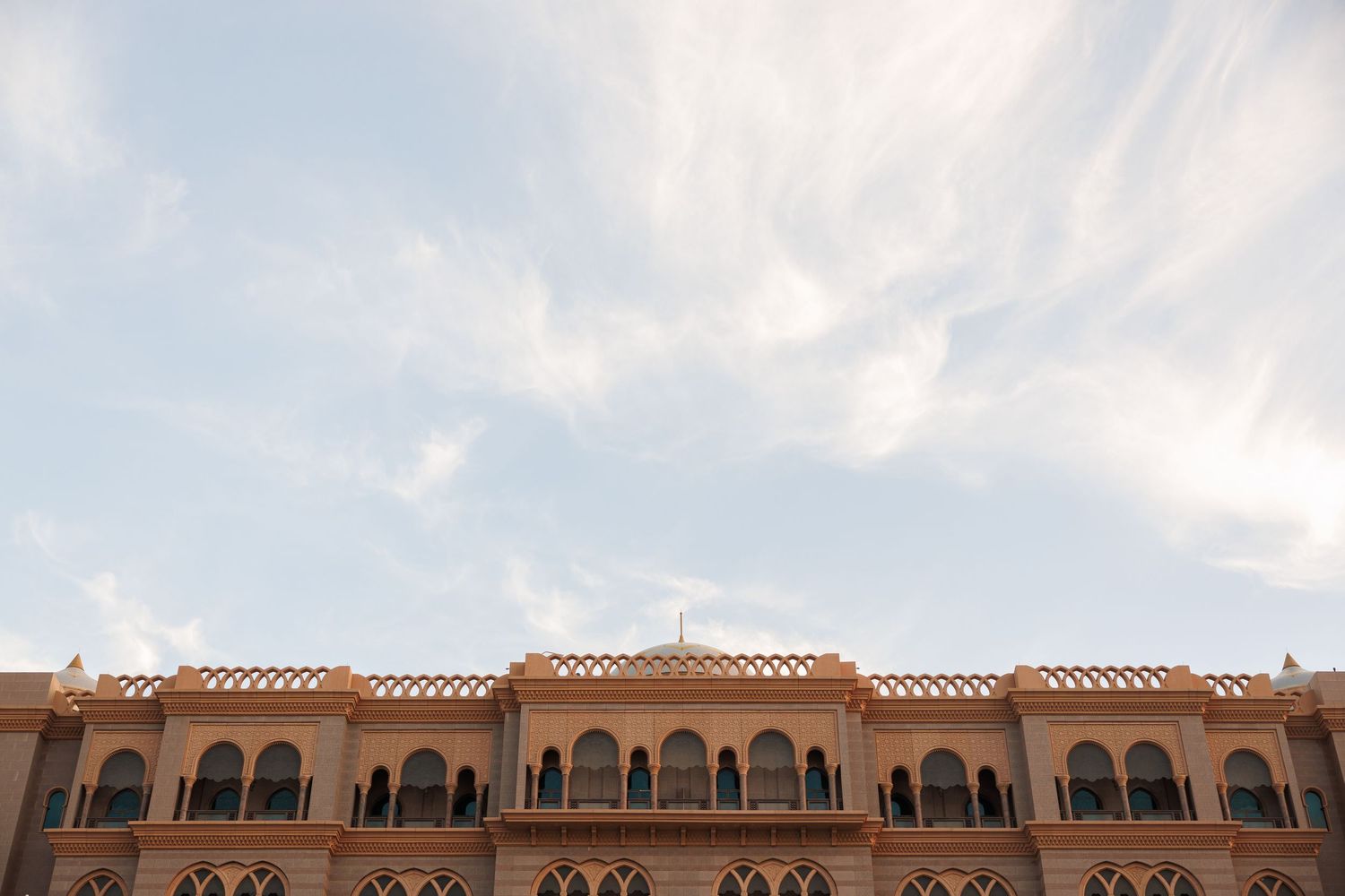 Ornate architectural details of a traditional Middle Eastern building with arched windows and decorative stonework.