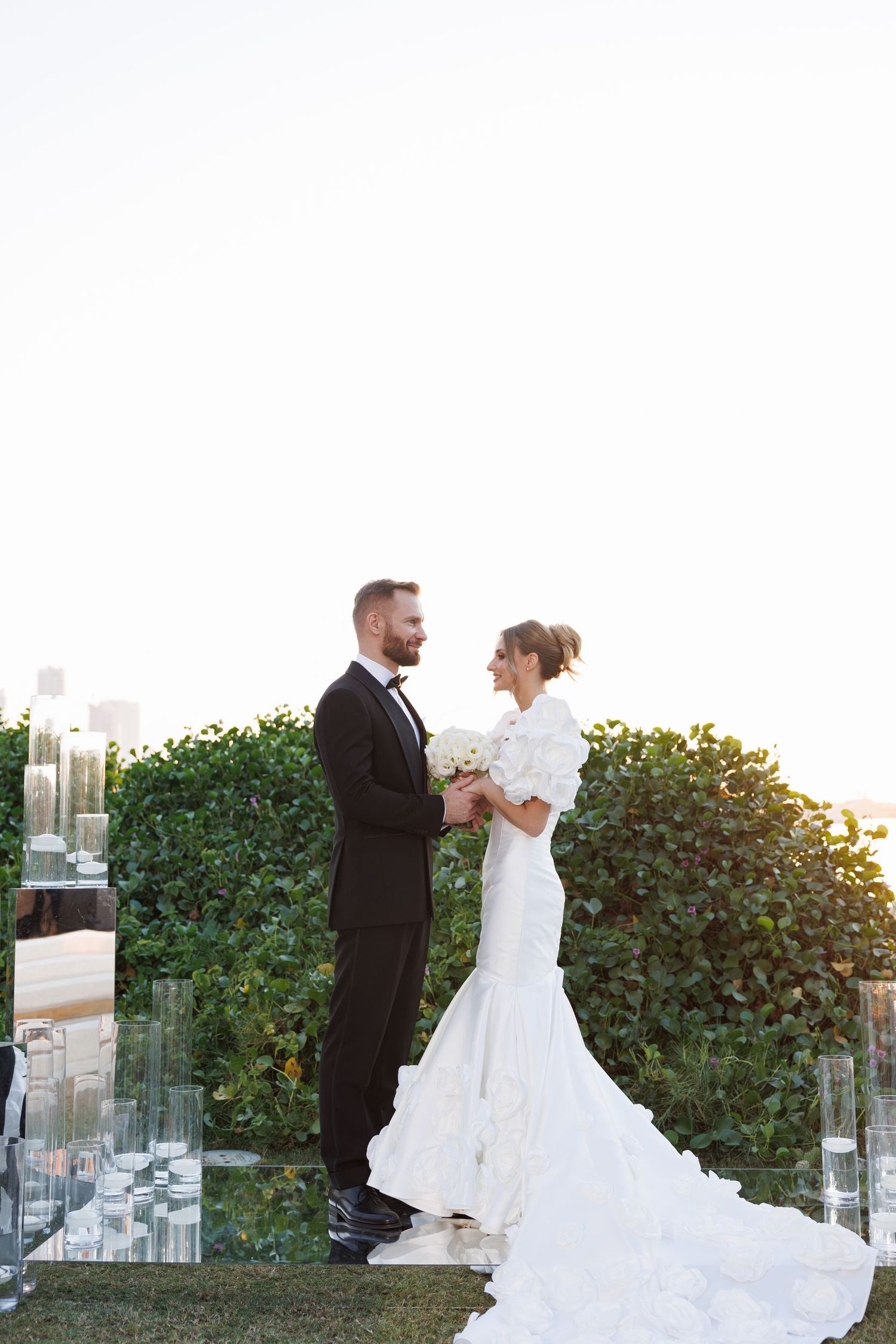 Romantic dance sequence at an outdoor wedding with modern skyscrapers in the background.