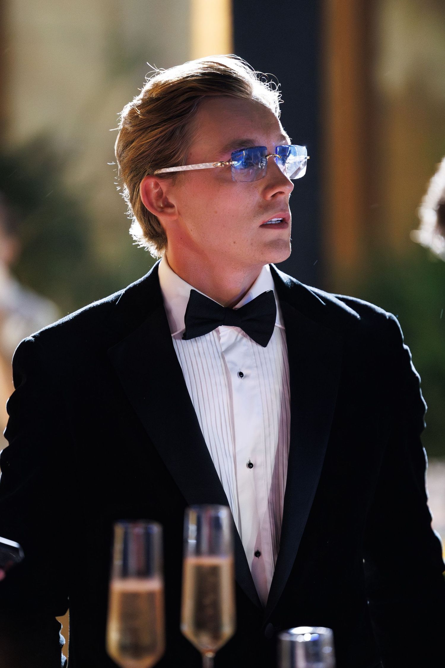 Person in formal attire and bow tie at an elegant evening event.