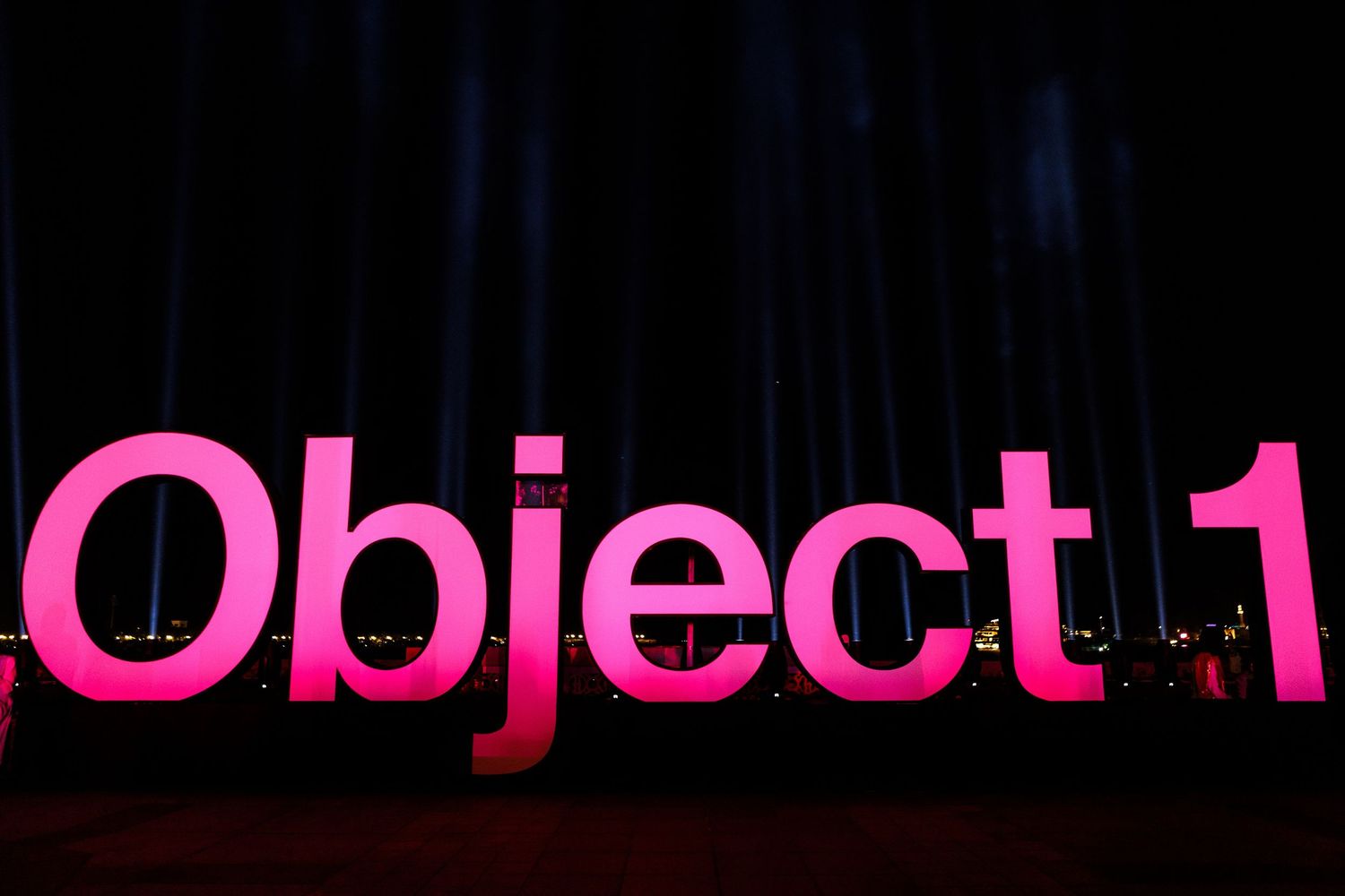 Modern event branding display with pink and black text elements.