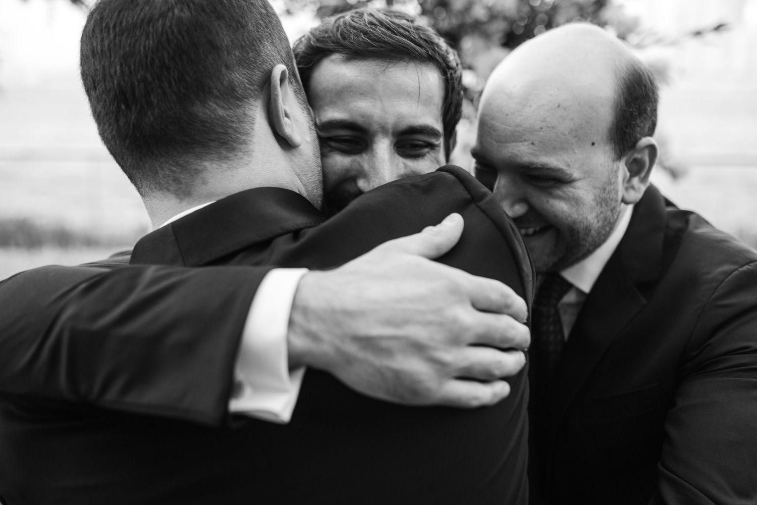 Emotional black and white candid moments between wedding party members.