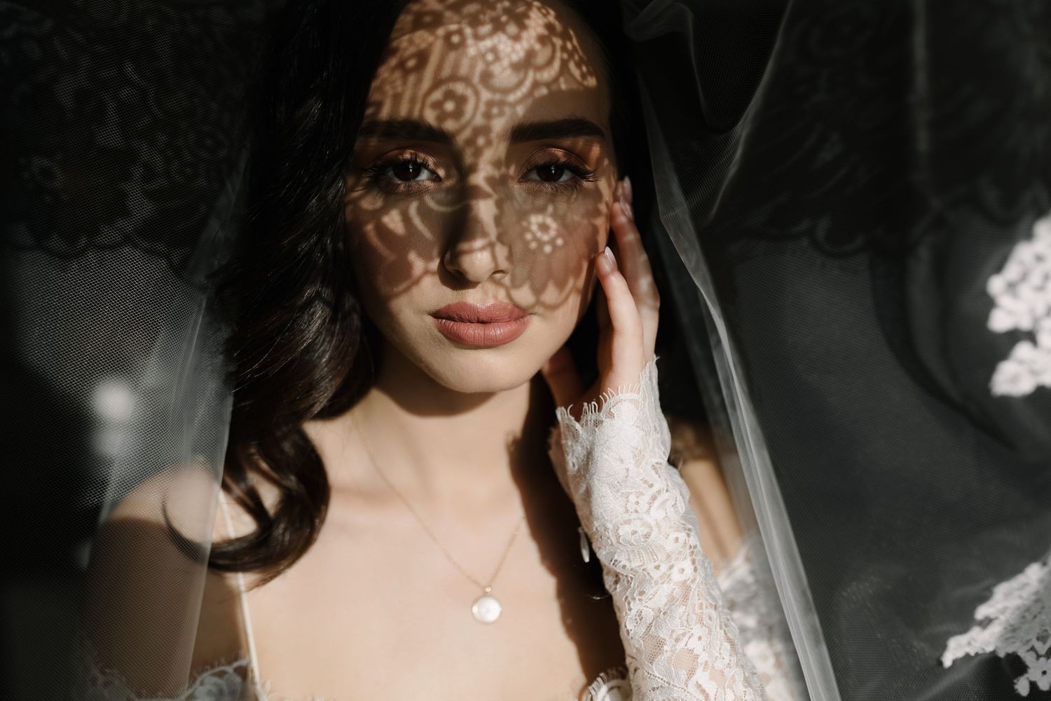 Romantic bridal portrait showcasing delicate lace details and soft lighting.