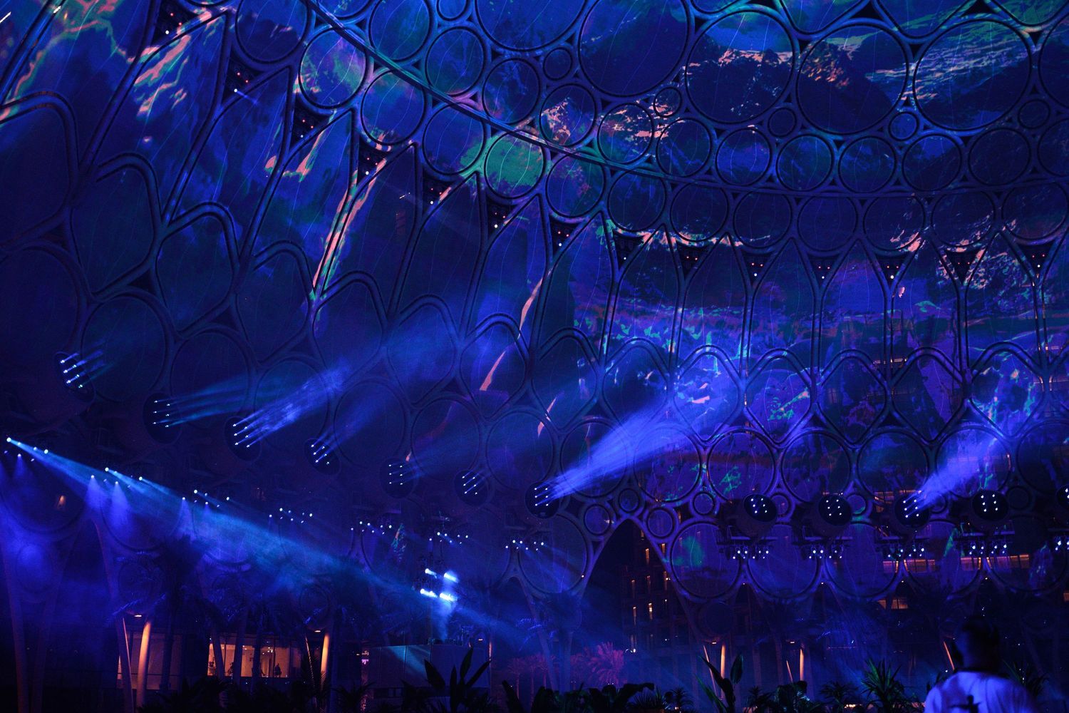 Large-scale performance venue with blue lighting effects creating an immersive atmosphere.