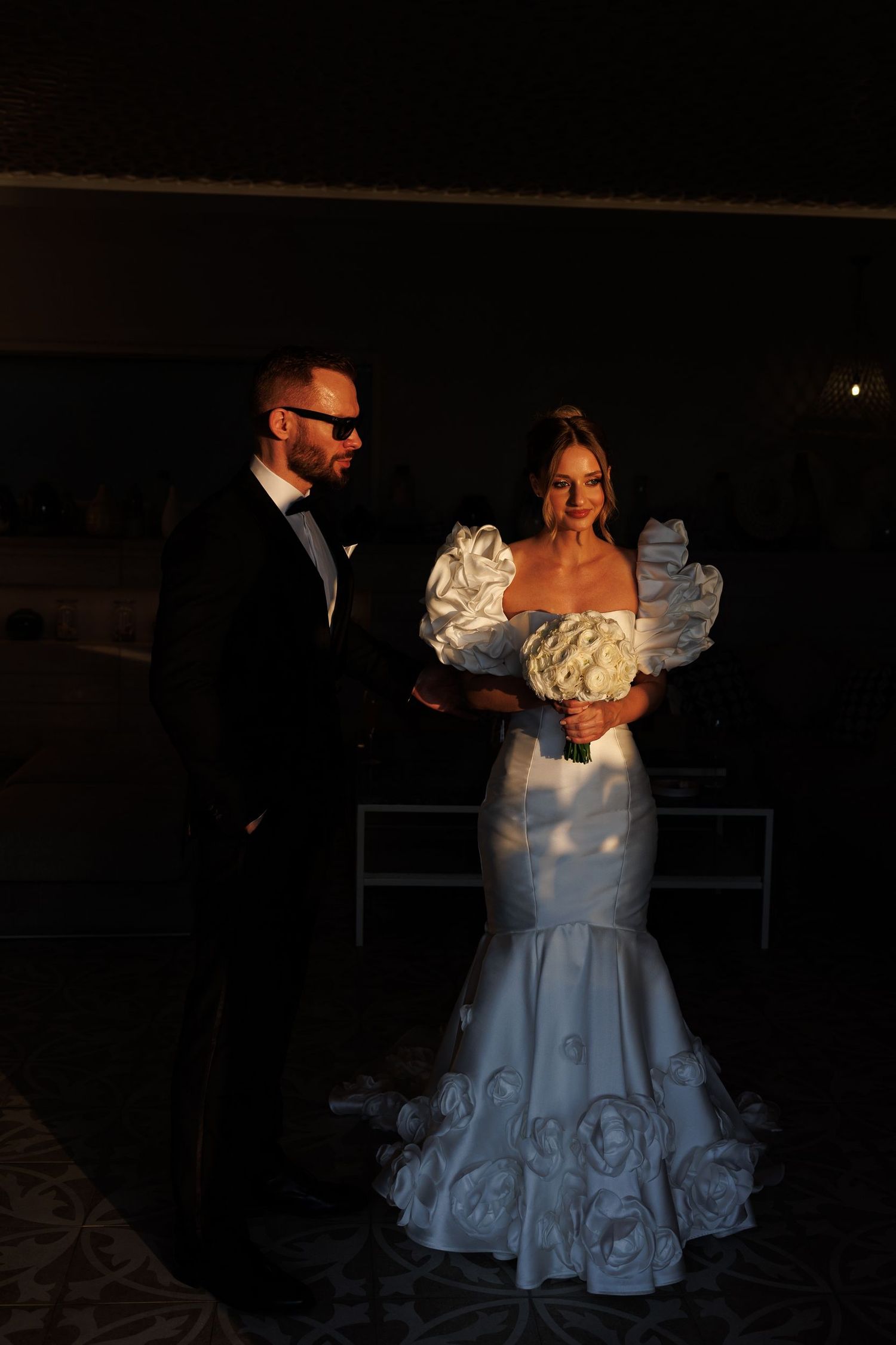 Dramatic nighttime wedding photos featuring a bride in a sculptural white gown.