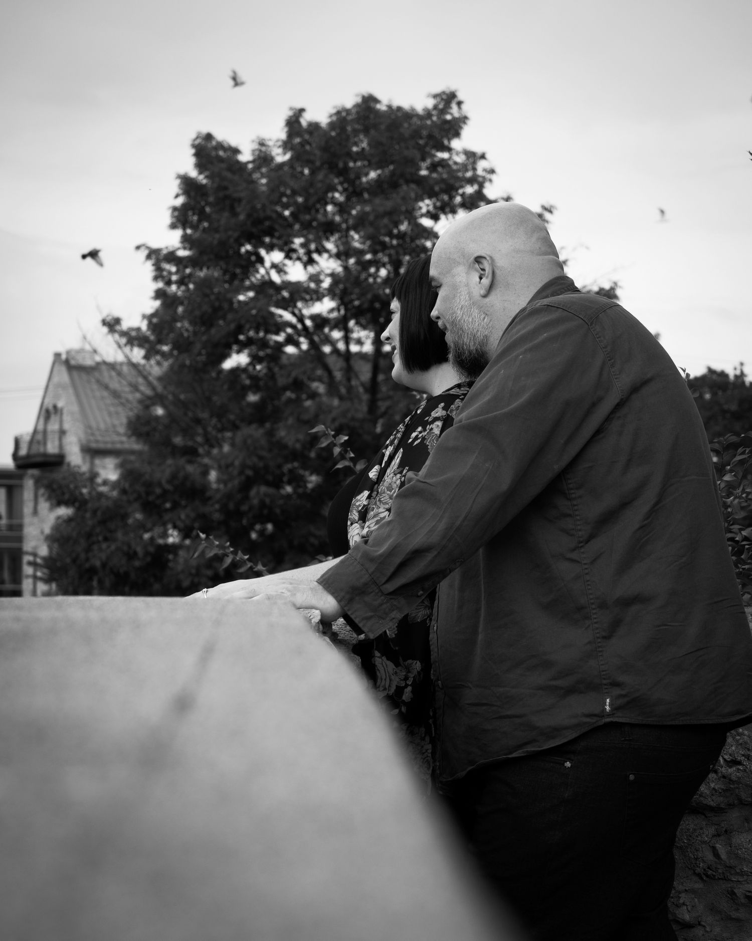 A romantic black and white sequence of a couple embracing outdoors.