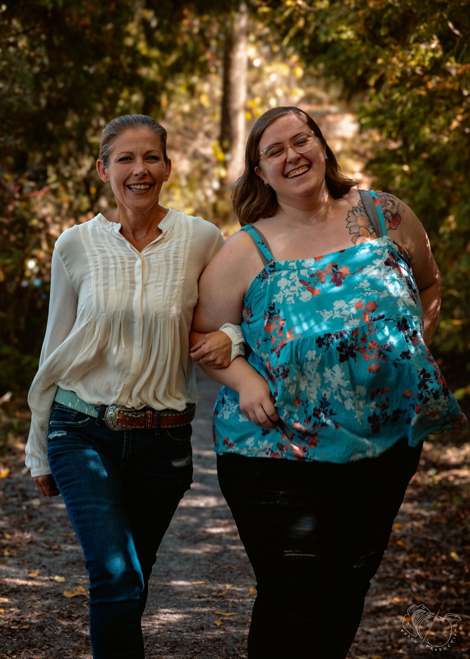 Two people in contrasting outfits share a joyful moment outdoors.