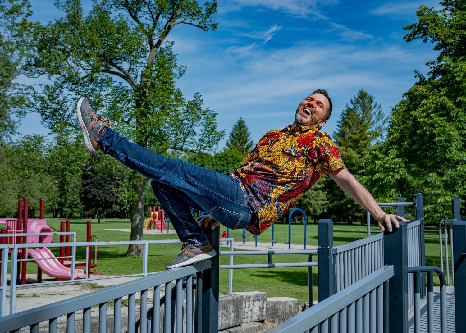 Playful sequence of someone performing acrobatic moves on a white railing outdoors.