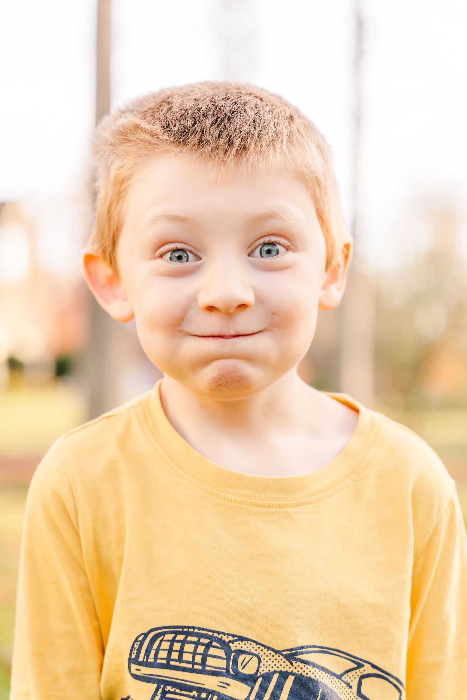 Greensboro, NC Family Photographer, Ryan Harden, Reidsville NC, young boy making a puffy cheek face.