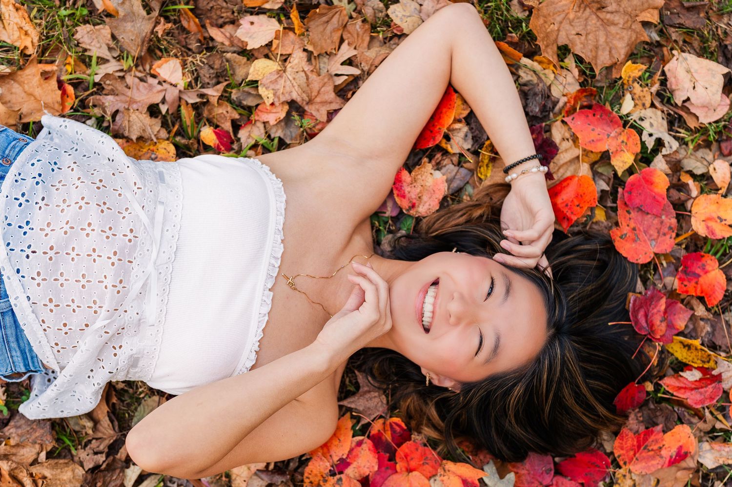 Greensboro, NC Senior Photographer, Reidsville, NC.  Ryan Harden.  stunning portrait of girl laying in bed of fall leaves.