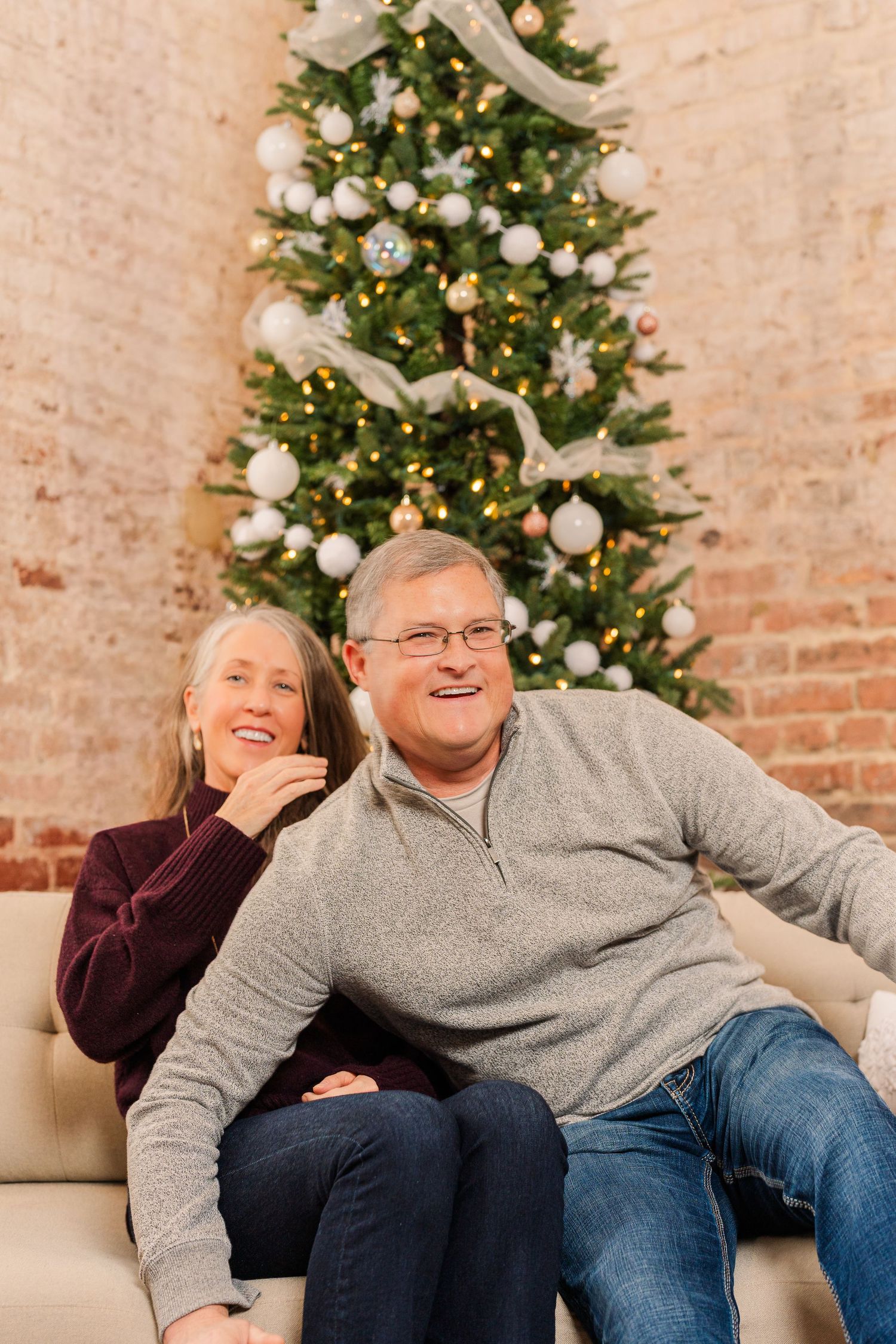Greensboro, NC Couples Photographer, Ryan Harden, Reidsville NC, Happy couple poses in front of Christmas tree for seasonal session.