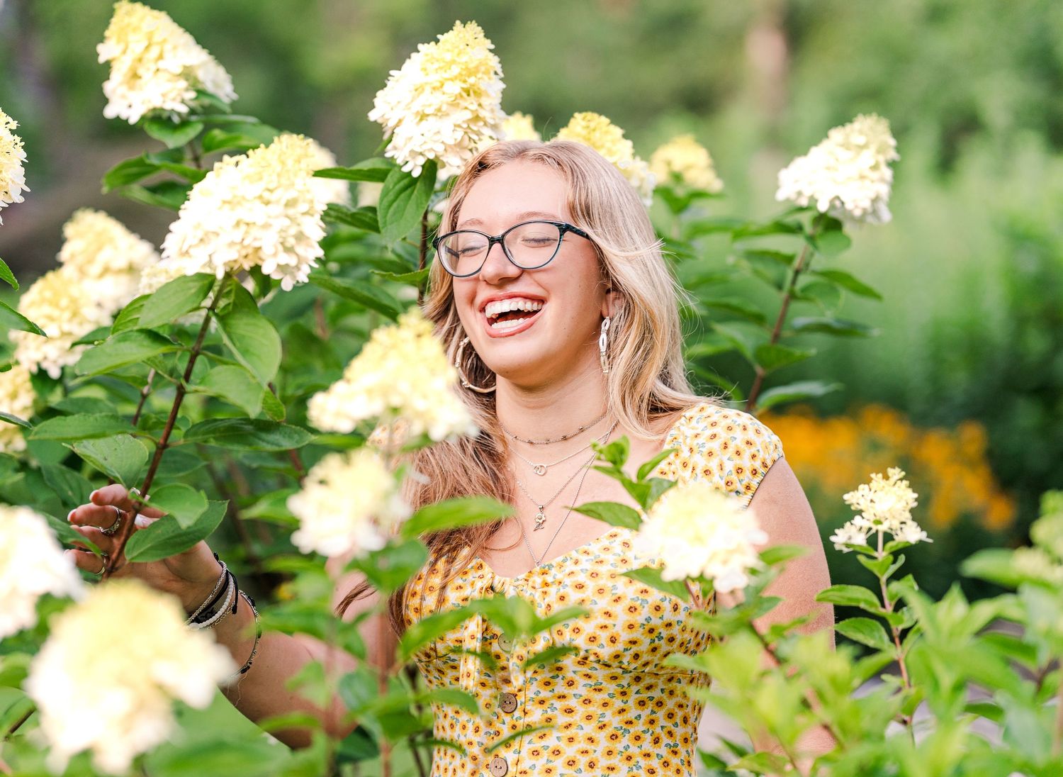 Greensboro, NC Senior Photographer.  Ryan Harden.  Reidsville, NC laughing girl in flowers