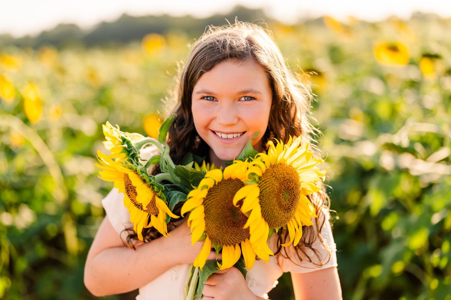 Greensboro, NC Family Photographer, Reidsville, NC.  Ryan Harden.  Girl holding arm full of sunflowers.
