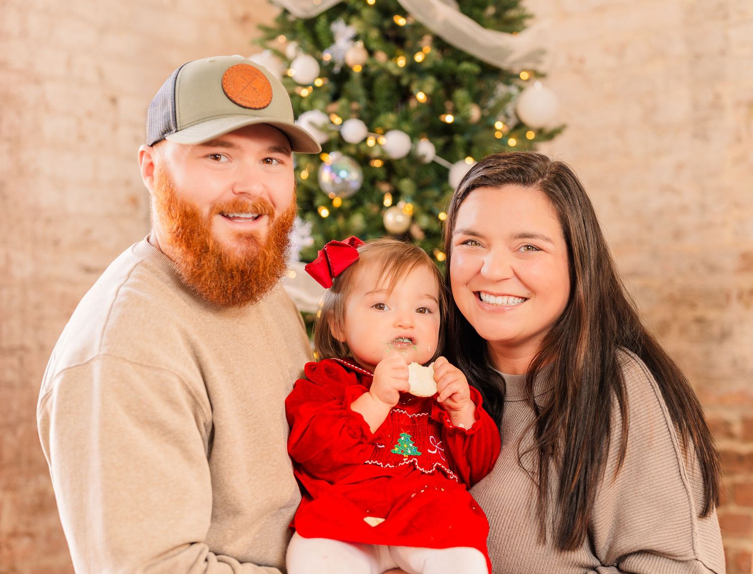Greensboro, NC Family Photographer, Ryan Harden, Reidsville NC, Happy family poses in front of Christmas tree for seasonal session.