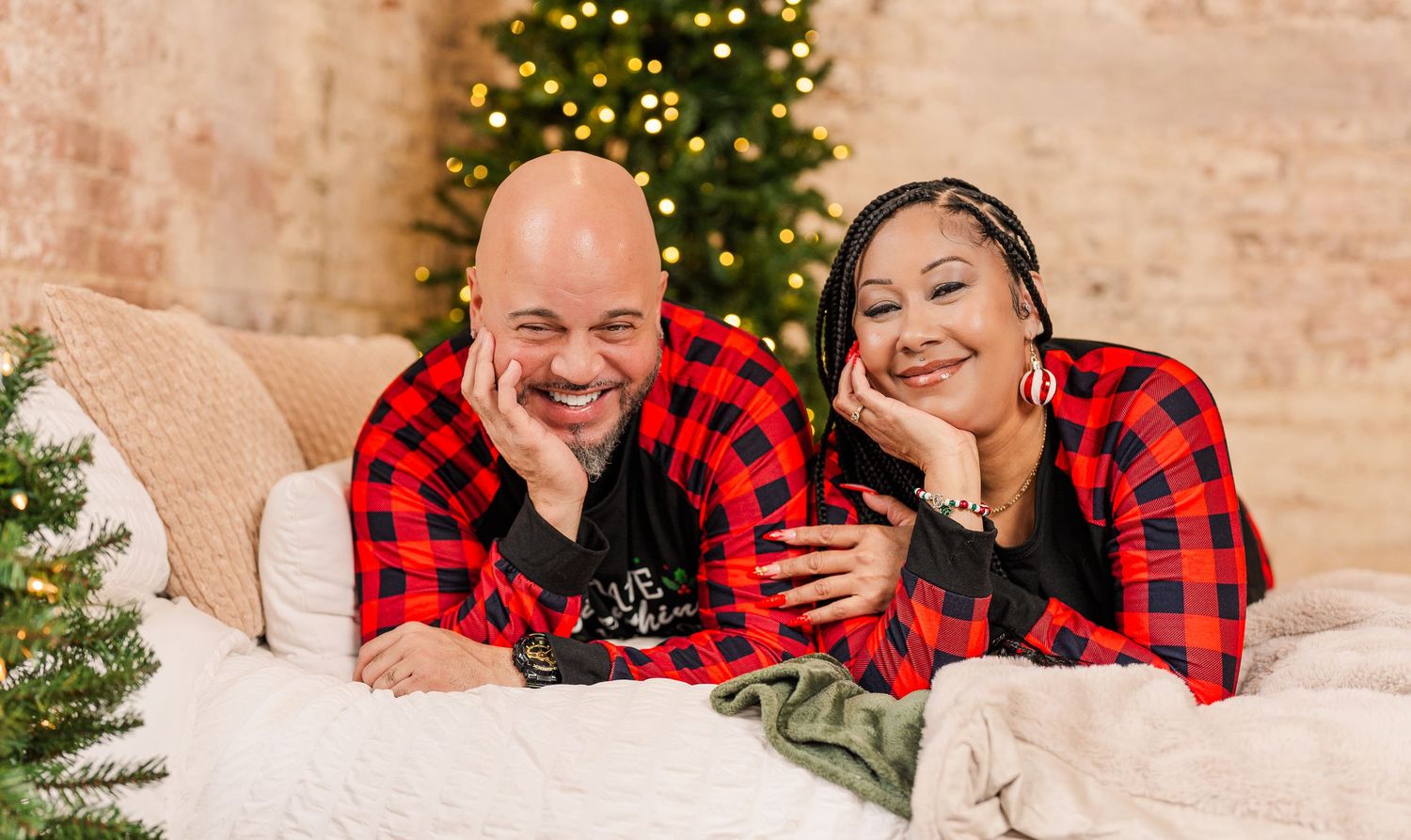 Greensboro, NC Couples Photographer, Ryan Harden, Reidsville NC, Happy couple on bed in front of Christmas tree for seasonal session.