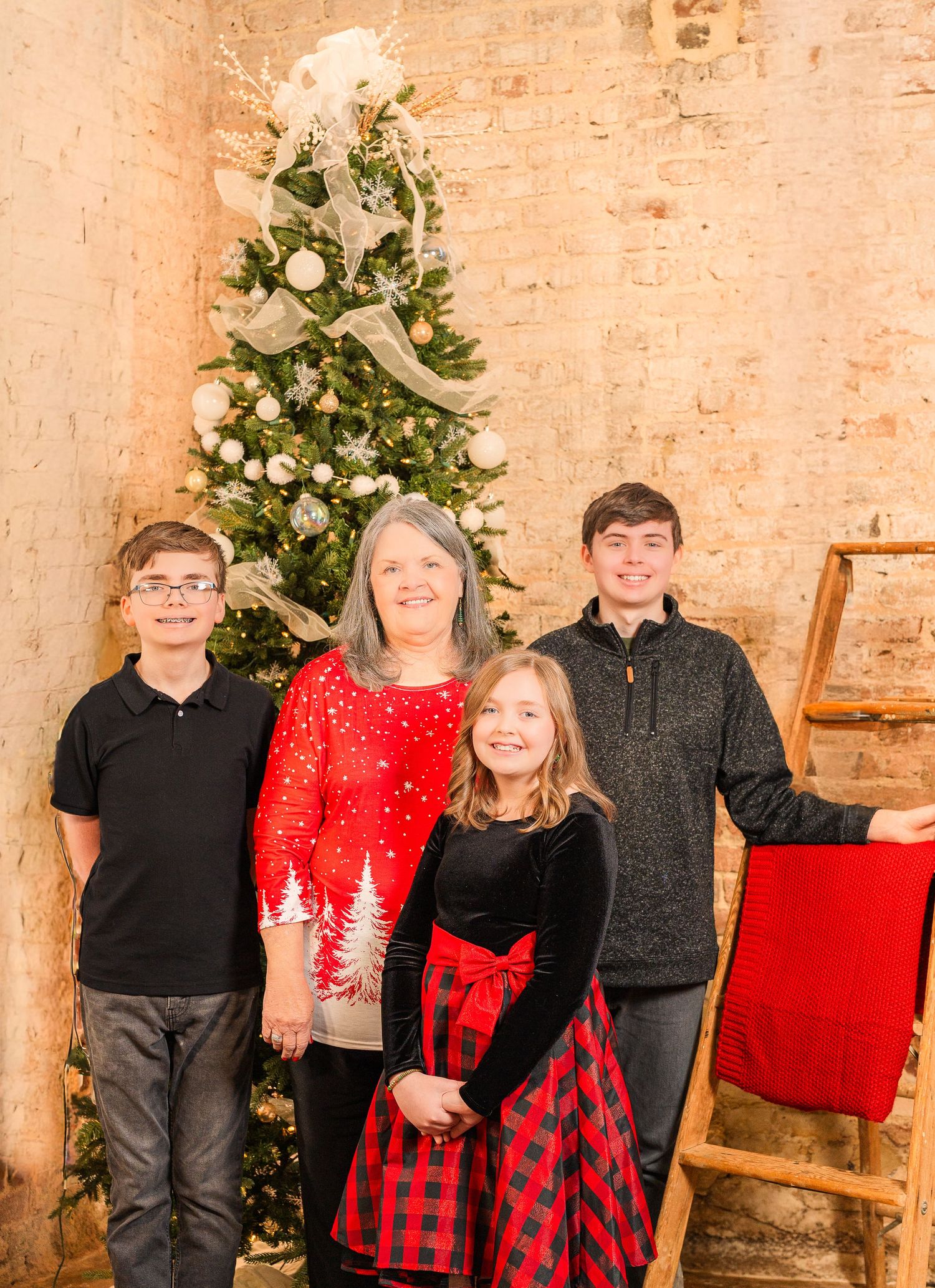 Greensboro, NC Family Photographer, Ryan Harden, Reidsville NC, grandmother and grandchildren pose in front of Christmas tree.