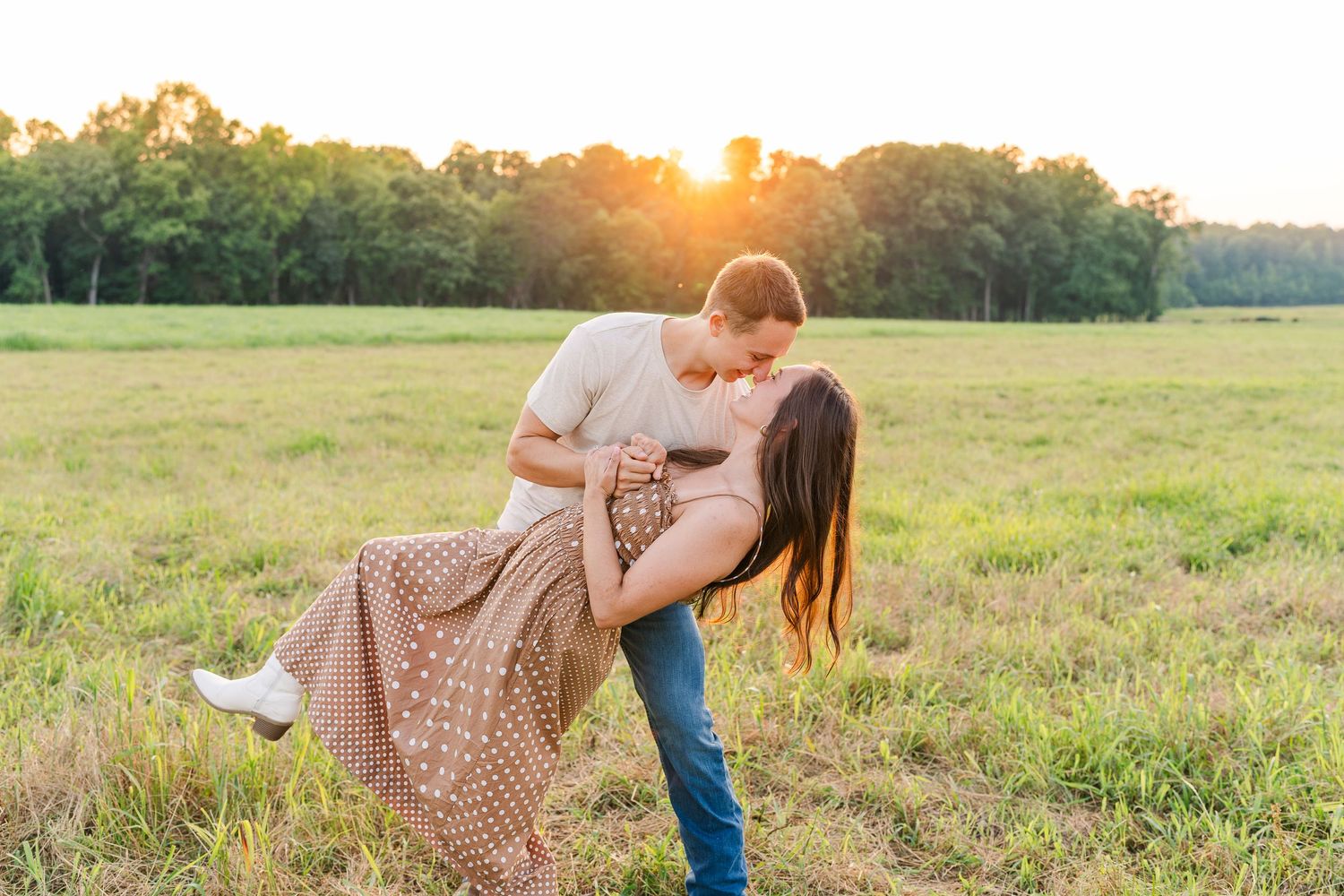 Greensboro, NC Couples Photographer, Ryan Harden, Reidsville NC, loving couple dances in a lush green field at sunset.