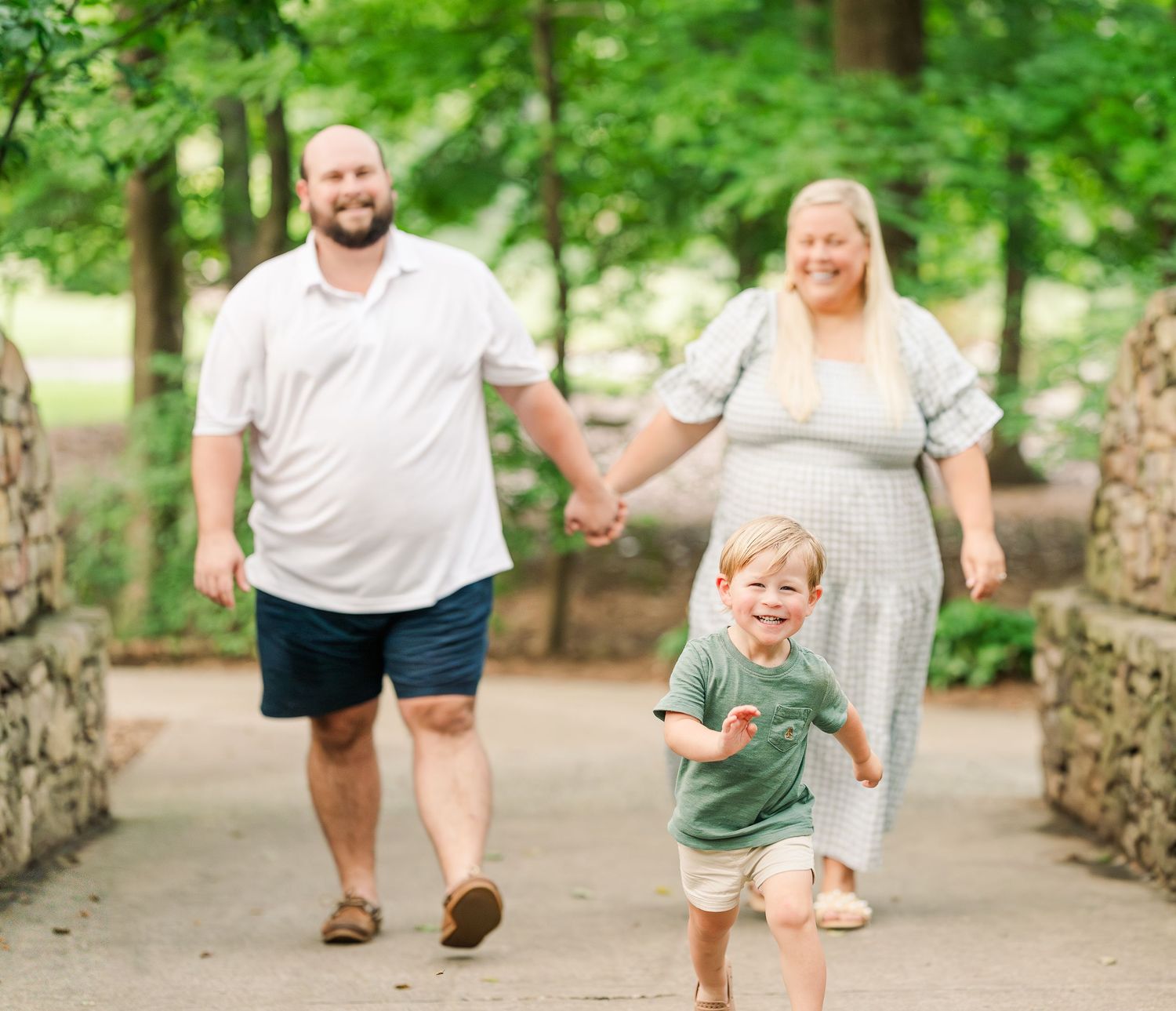 Greensboro, NC Family Photographer, Ryan Harden, Reidsville NC.  Child running with parents out of focus behind.
