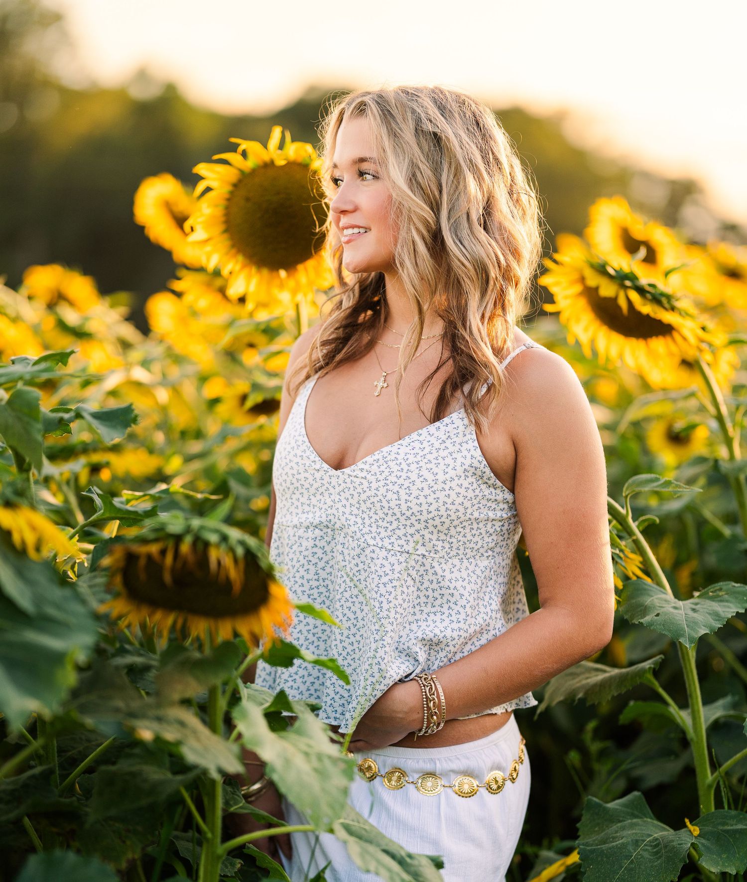 Greensboro, NC Senior Photographer, Reidsville, NC.  Ryan Harden. Stunning senior portrait in girl in sunflowers illuminated by sunlight