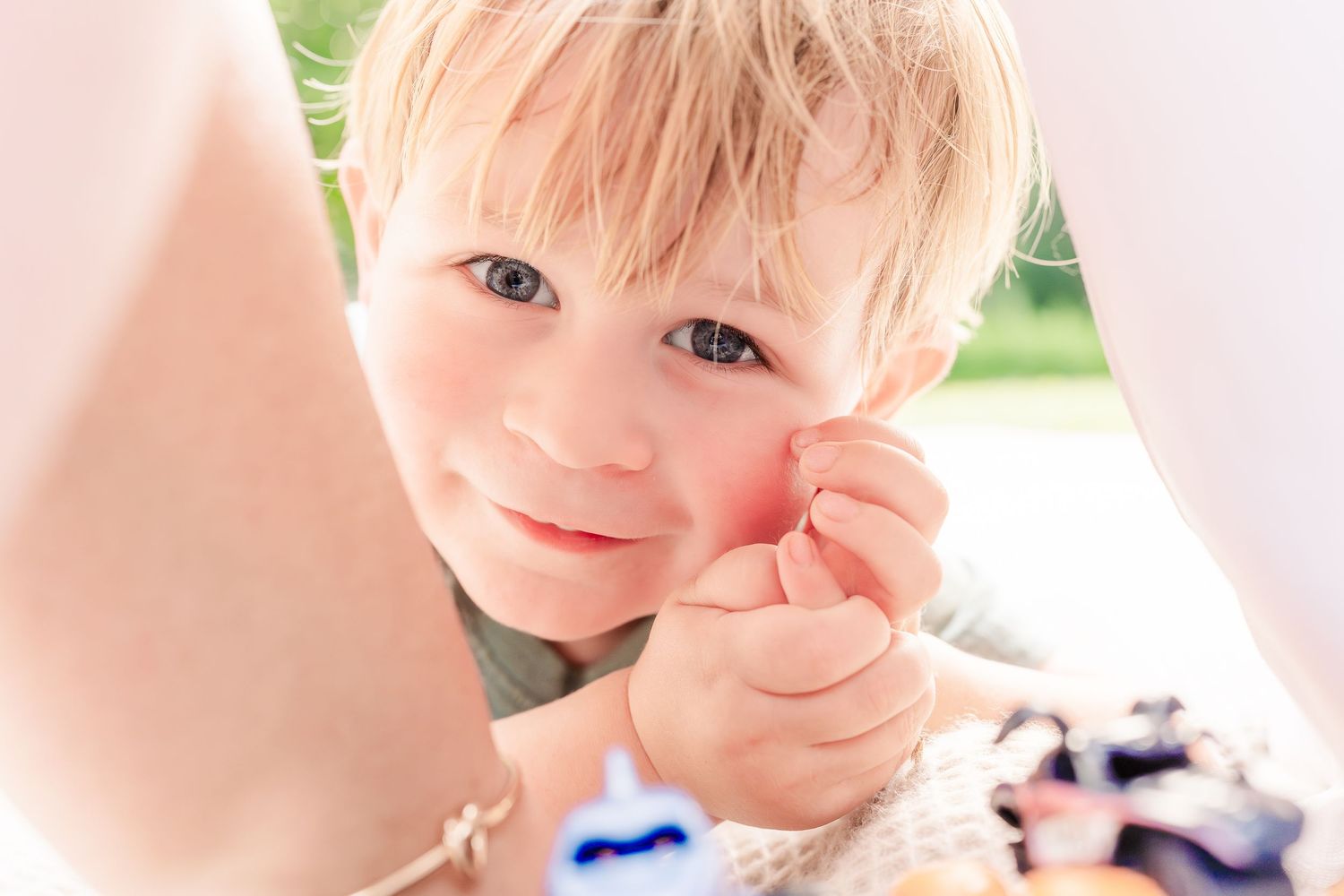Greensboro, NC Family Photographer, Ryan Harden, Reidsville NC.  Child close up of face between parents' arms