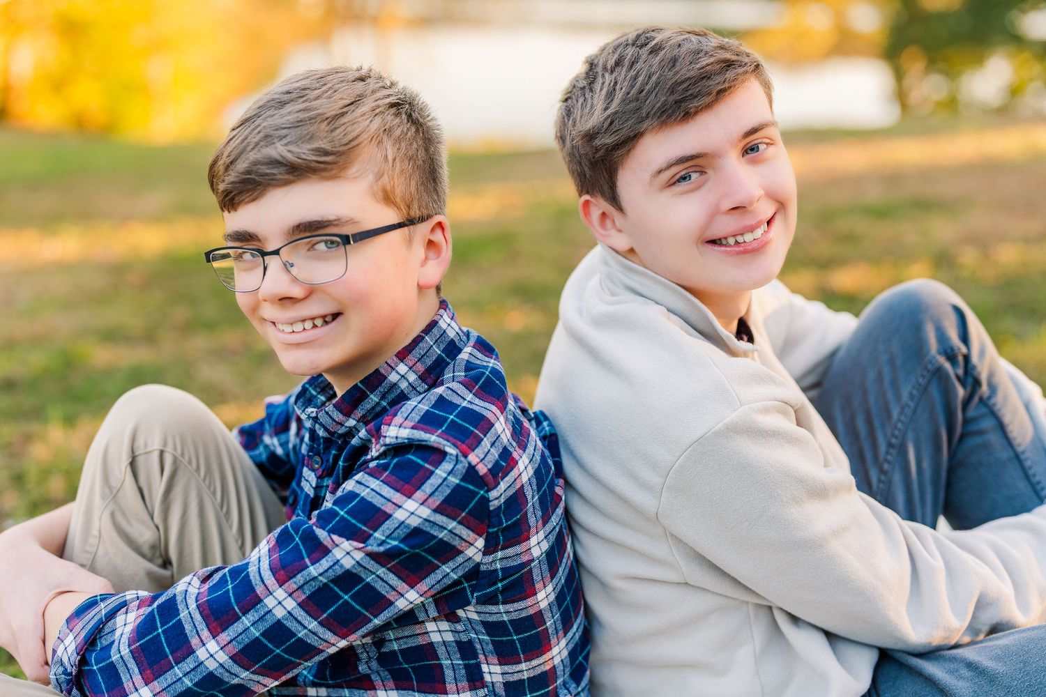 Greensboro, NC Family Photographer, Reidsville, NC.  Ryan Harden. Portrait of brothers at lake with fall leaves behind them.