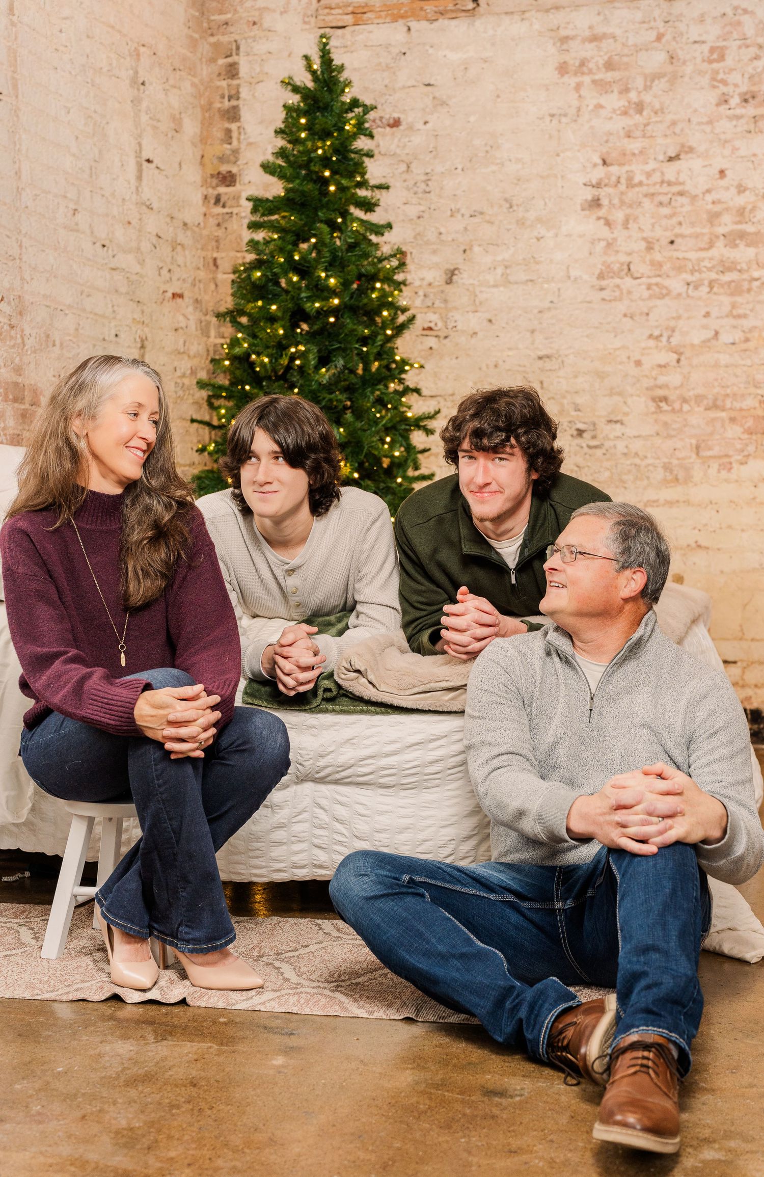 Greensboro, NC Family Photographer, Ryan Harden, Reidsville NC, Happy family poses in front of Christmas tree for seasonal session.