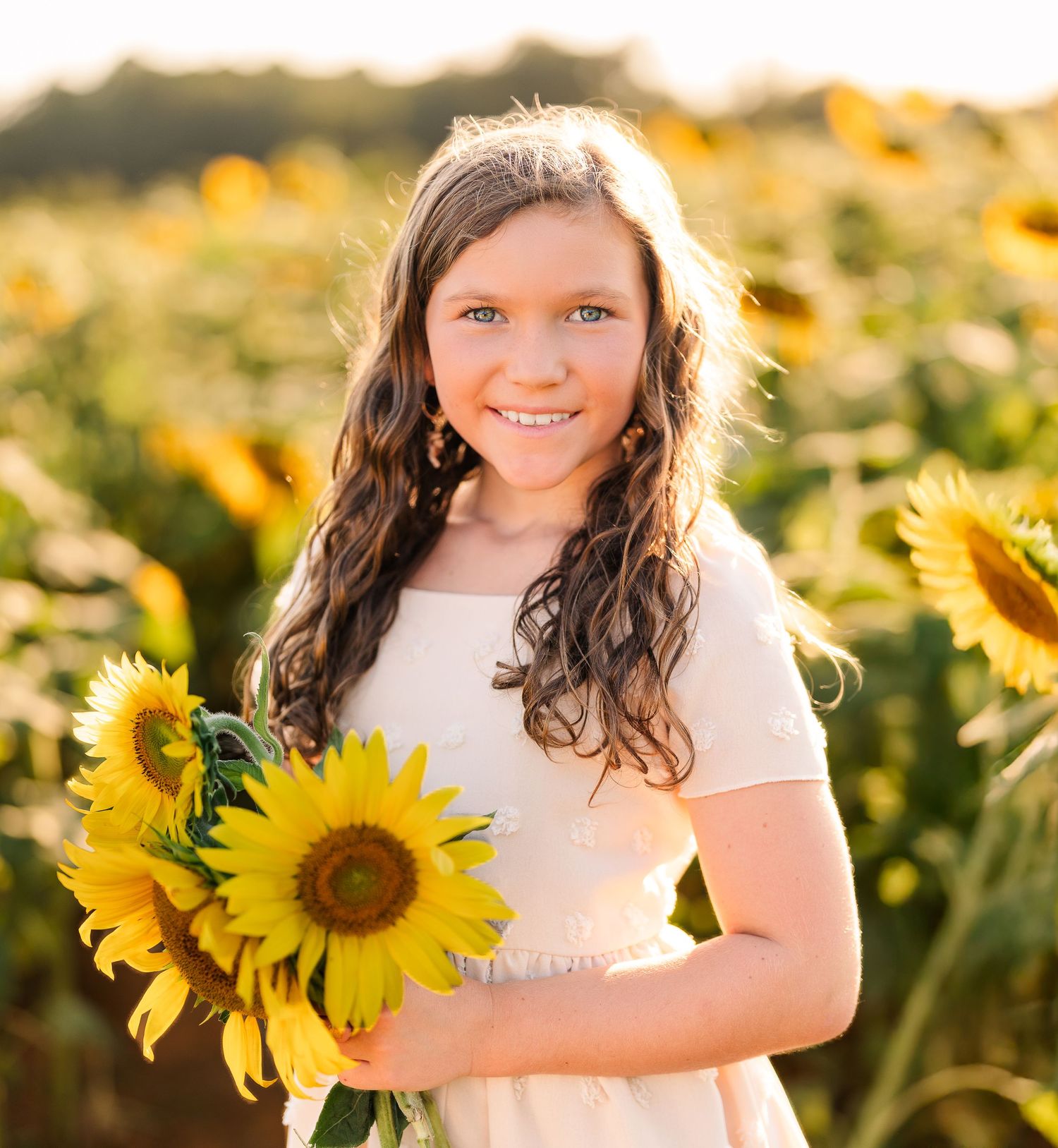 Greensboro, NC Family Photographer, Reidsville, NC.  Ryan Harden.  Daughter in field of sunflowers and golden sunset falls behind her.