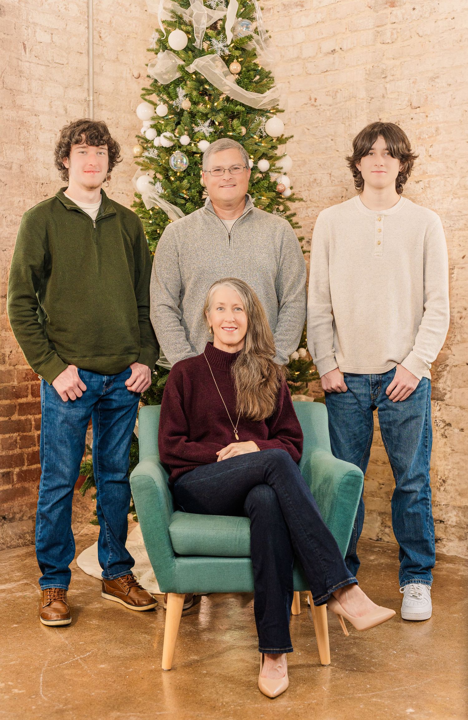 Greensboro, NC Family Photographer, Ryan Harden, Reidsville NC, Happy family poses in front of Christmas tree for seasonal session.