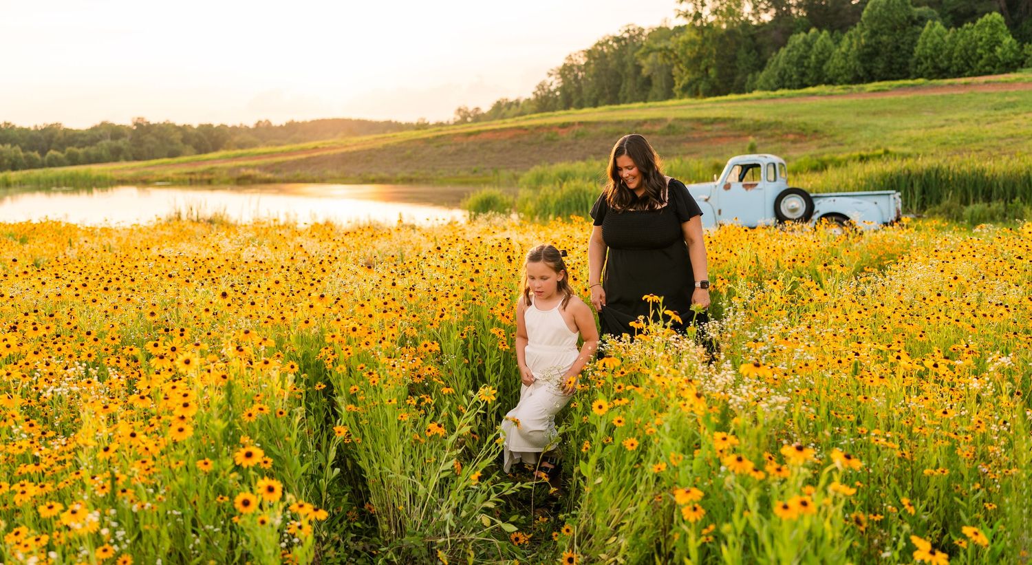 Greensboro, NC Family Photographer, Ryan Harden, Reidsville NC, Greensboro NC.  Mother walking through field of flowers with daughter.