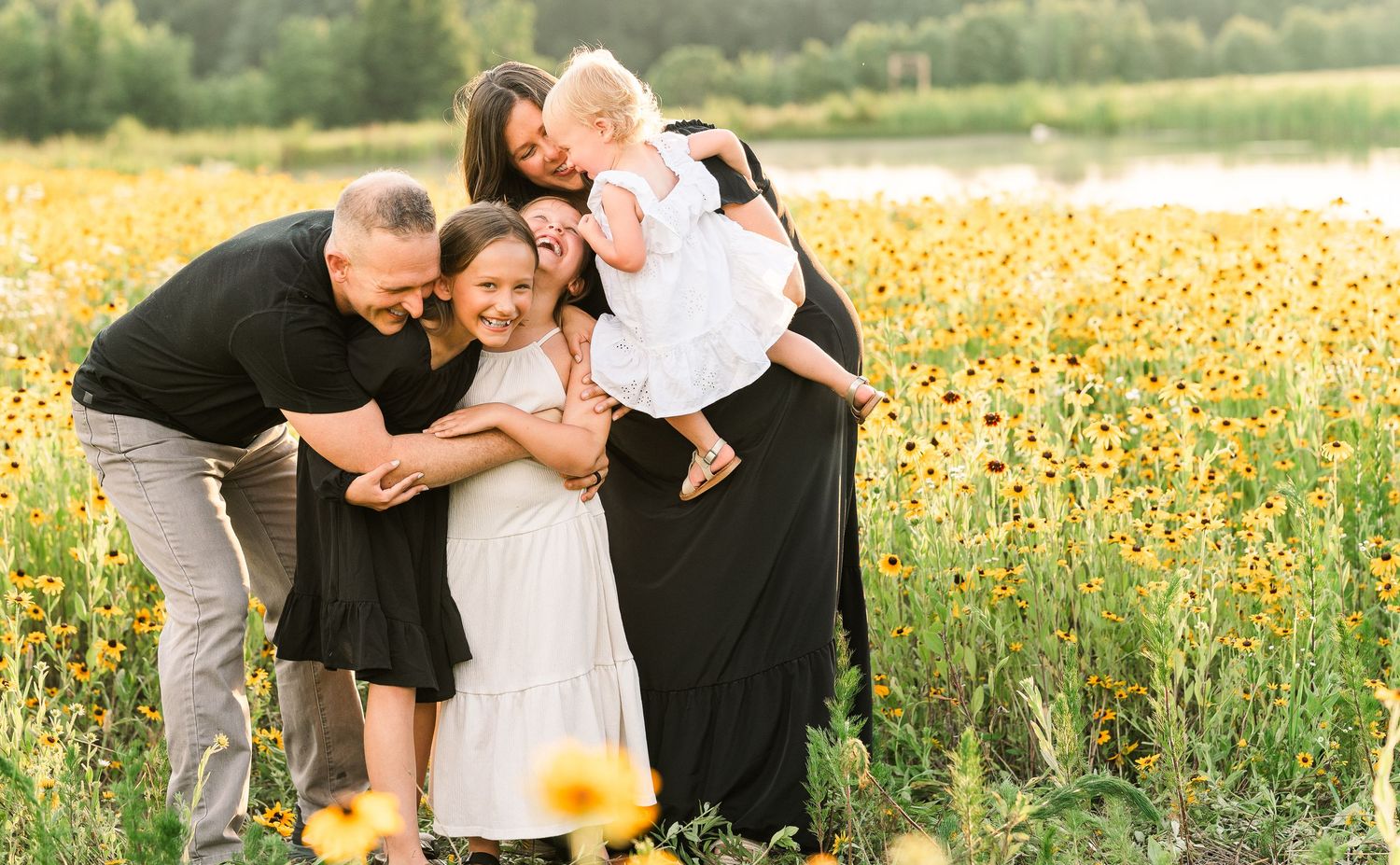 Greensboro, NC Family Photographer, Ryan Harden, Reidsville NC, happy family in field of daisies at sunset