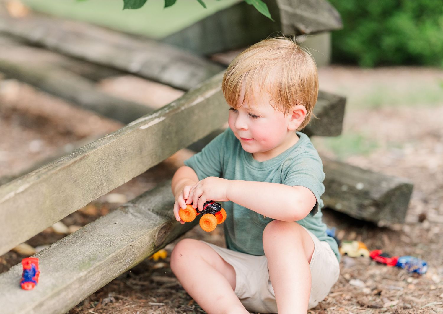 Greensboro, NC Family Photographer, Ryan Harden, Reidsville NC.  Child playing with toy trucks.