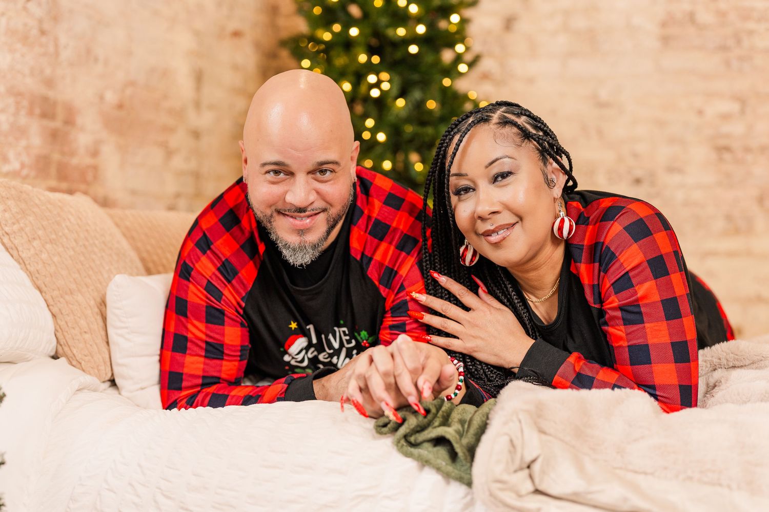 Greensboro, NC Couples Photographer, Ryan Harden, Reidsville NC, Happy couple on bed in front of Christmas tree for seasonal session.