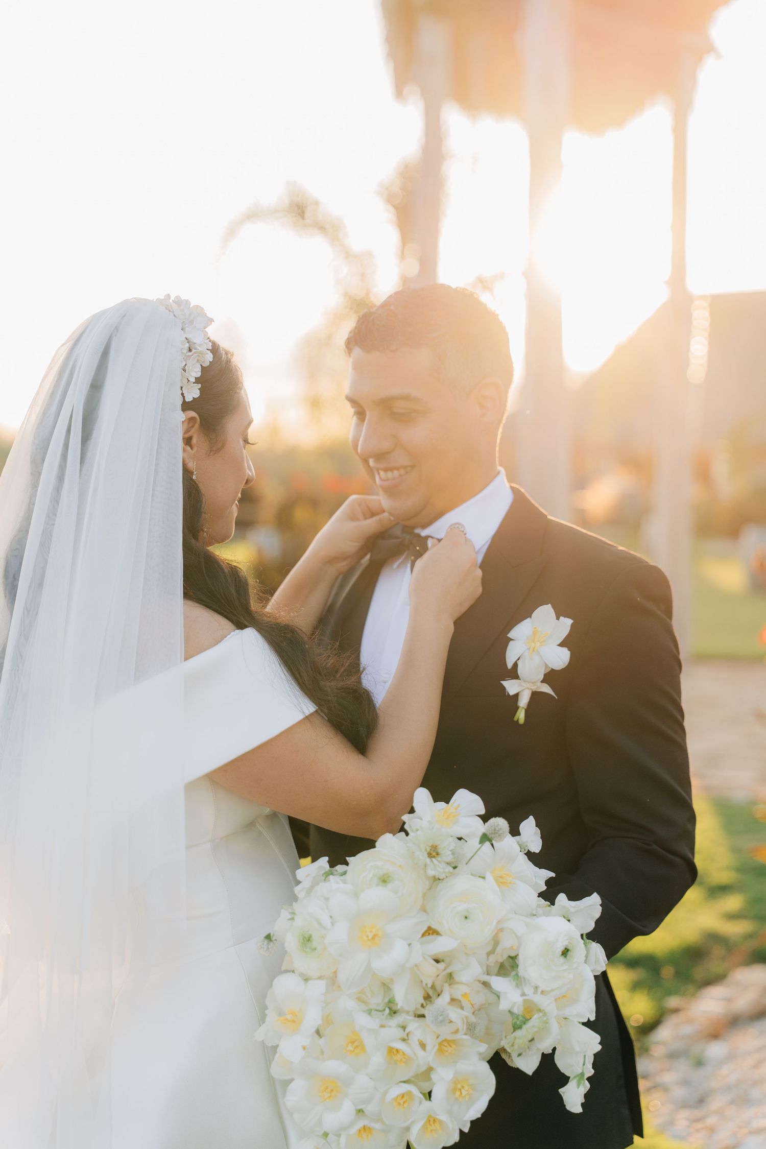 Sunset wedding portraits capture intimate moments between bride and groom against golden light.