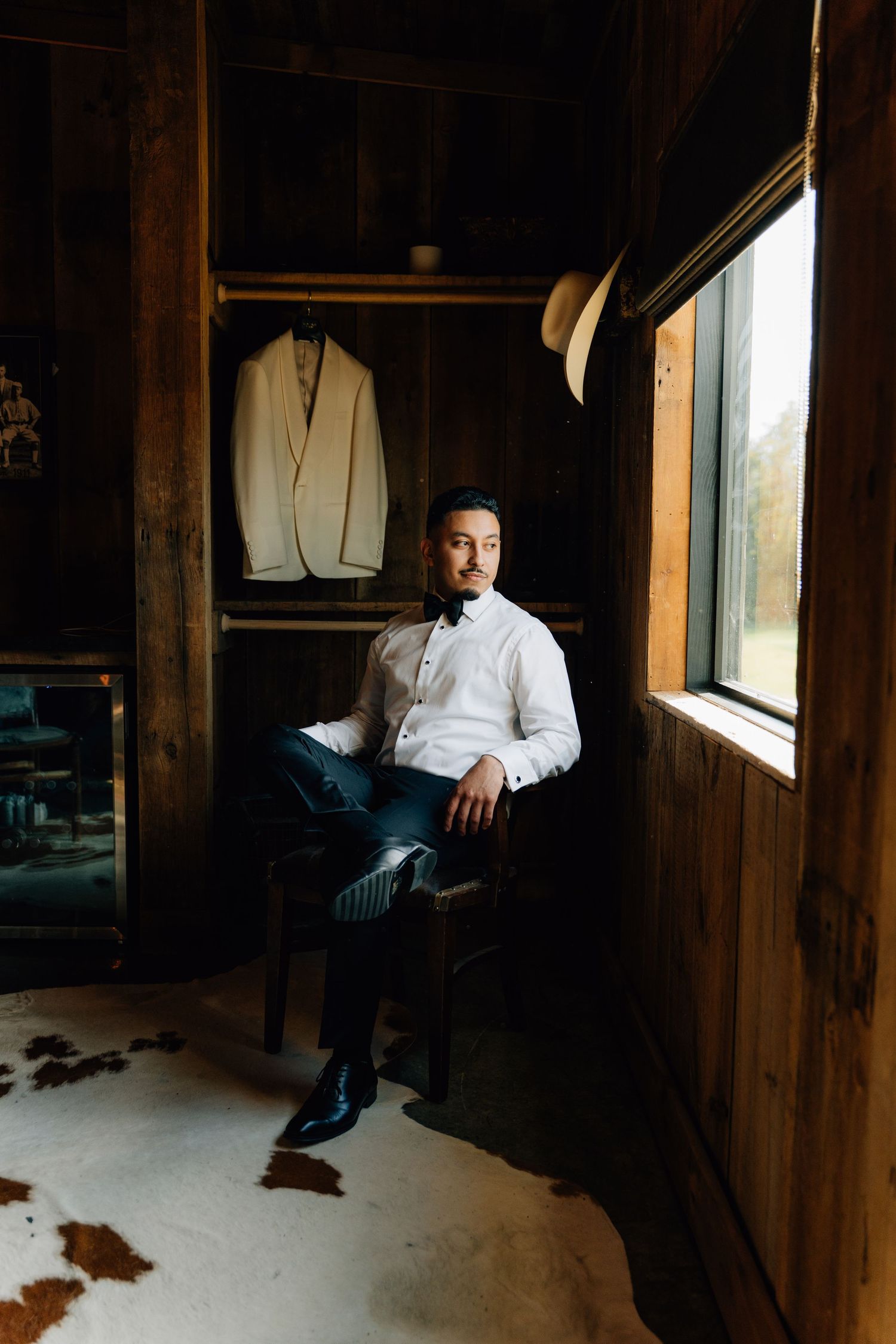 Moody interior photography of a rustic wooden room with natural window lighting.