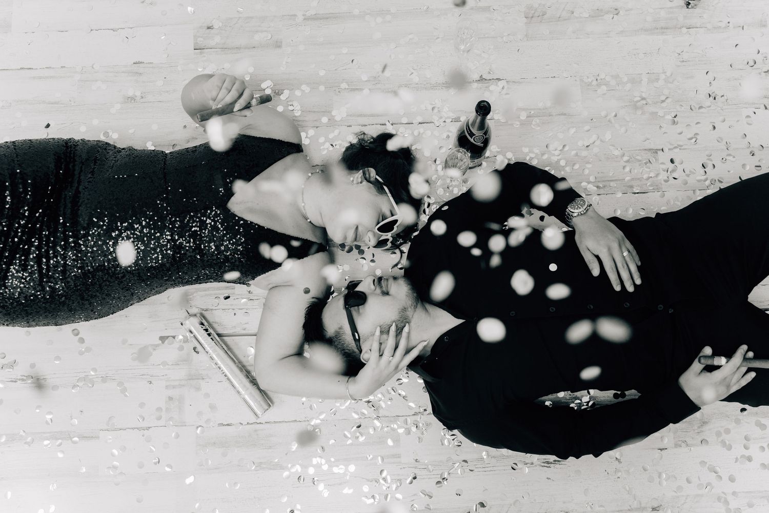 A black and white vintage photograph showing polka dot fabric and objects scattered on a light surface.