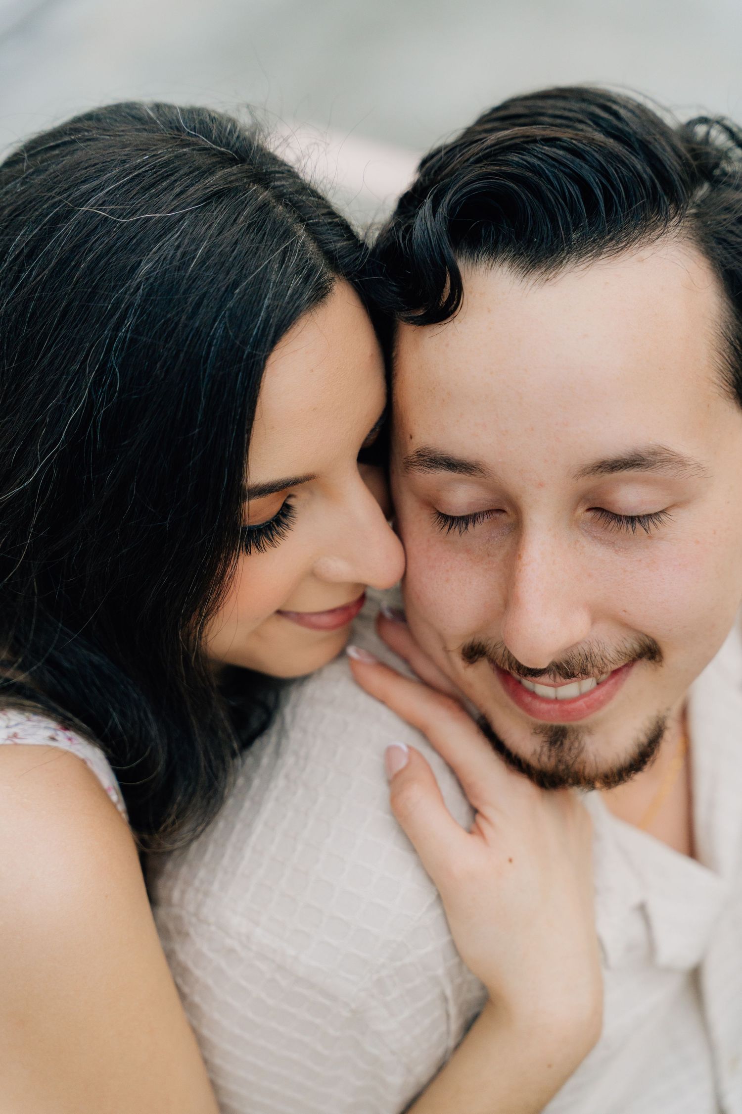 Intimate close-up series of a couple sharing tender moments in white clothing.