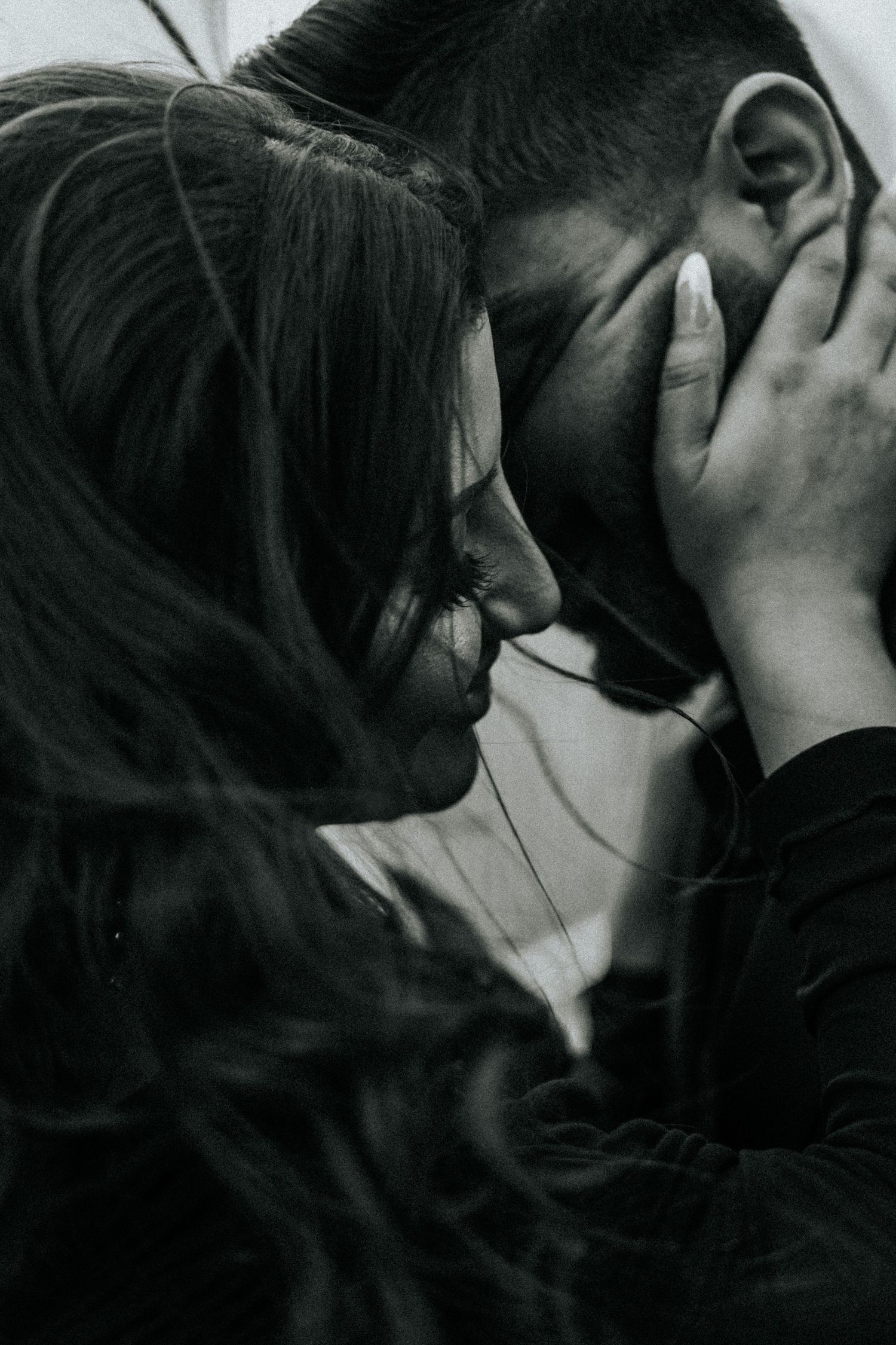 Intimate black and white close-up capturing an emotional moment between two people.