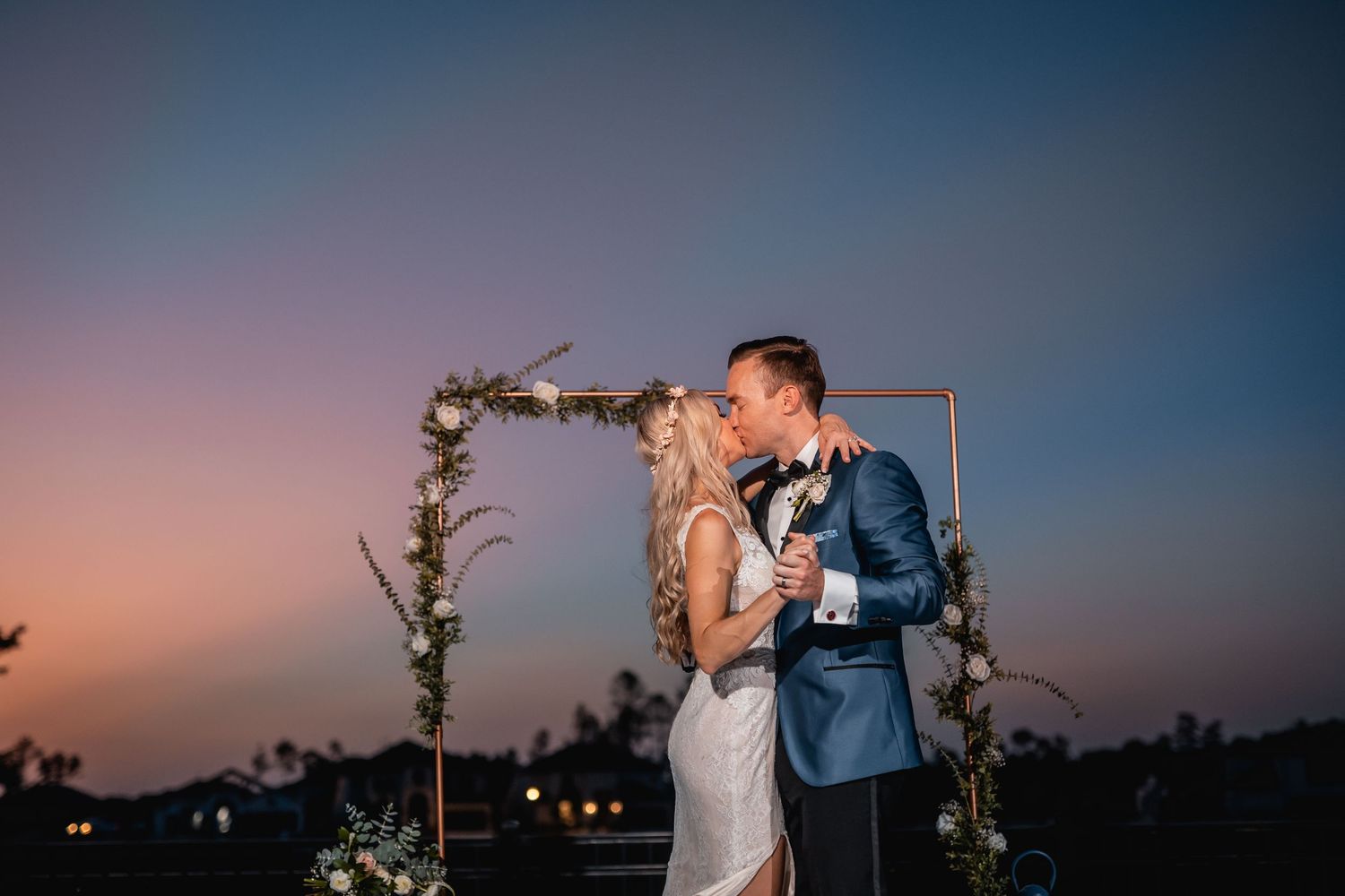 Romantic sunset wedding portraits with dramatic sky and intimate poses.