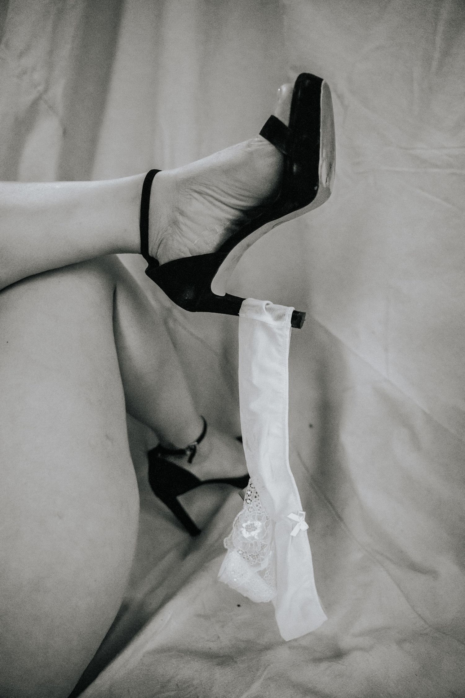 Black and white artistic photo series showing feet and legs with white socks in abstract compositions.