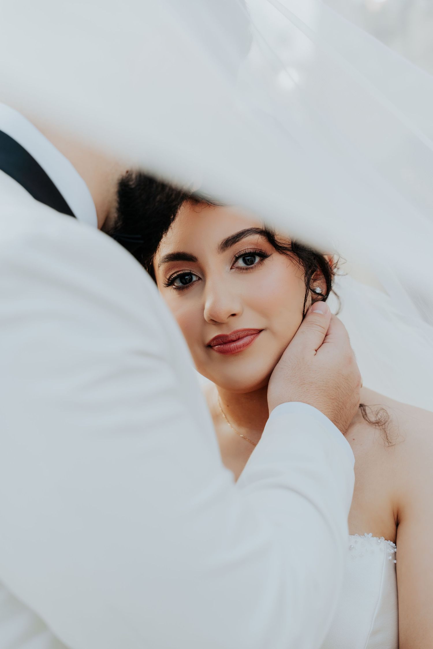 Intimate close-up wedding portrait showing tender moment between couple.