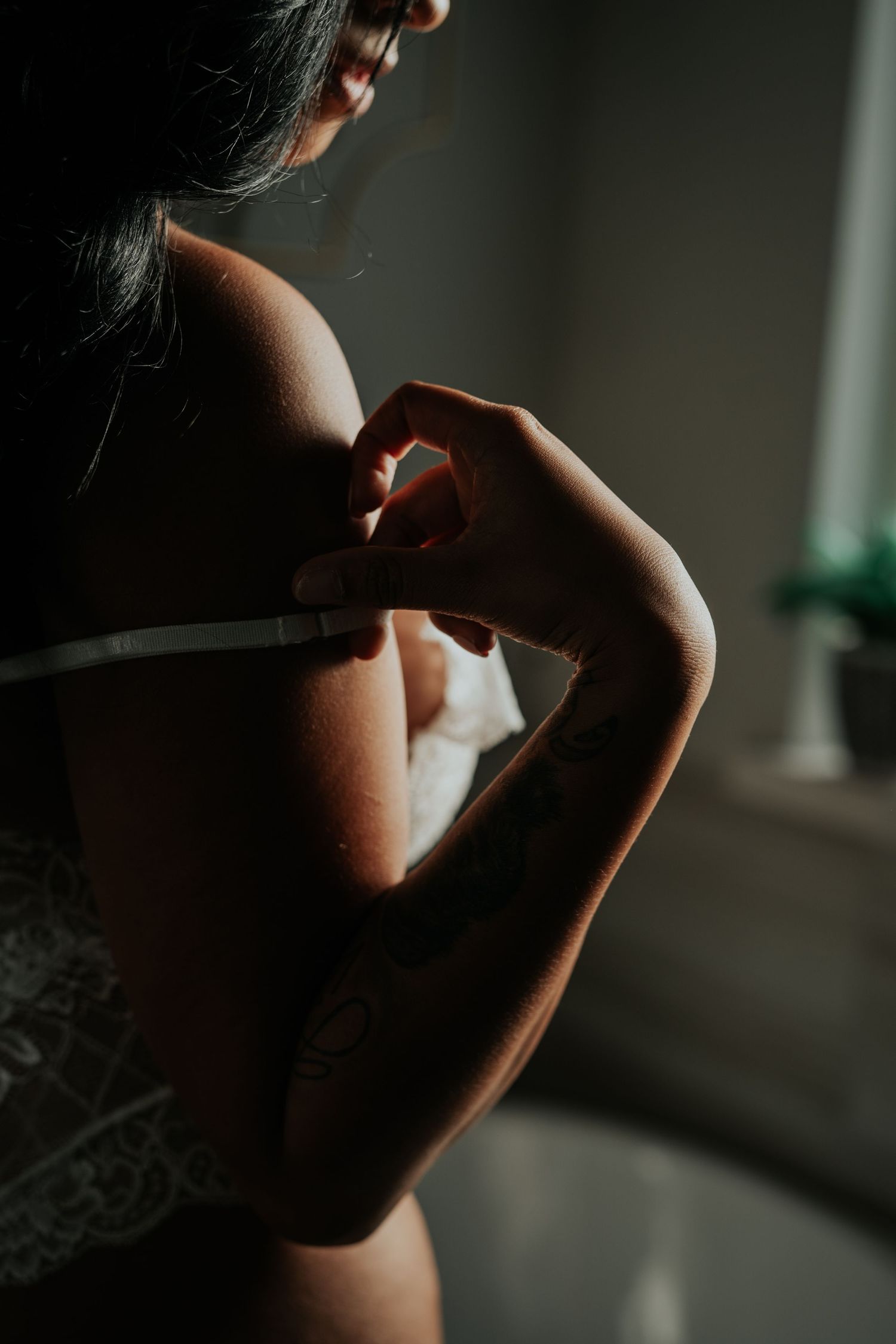 Silhouetted profile of a person smoking in a dimly lit room creating a moody atmospheric scene.